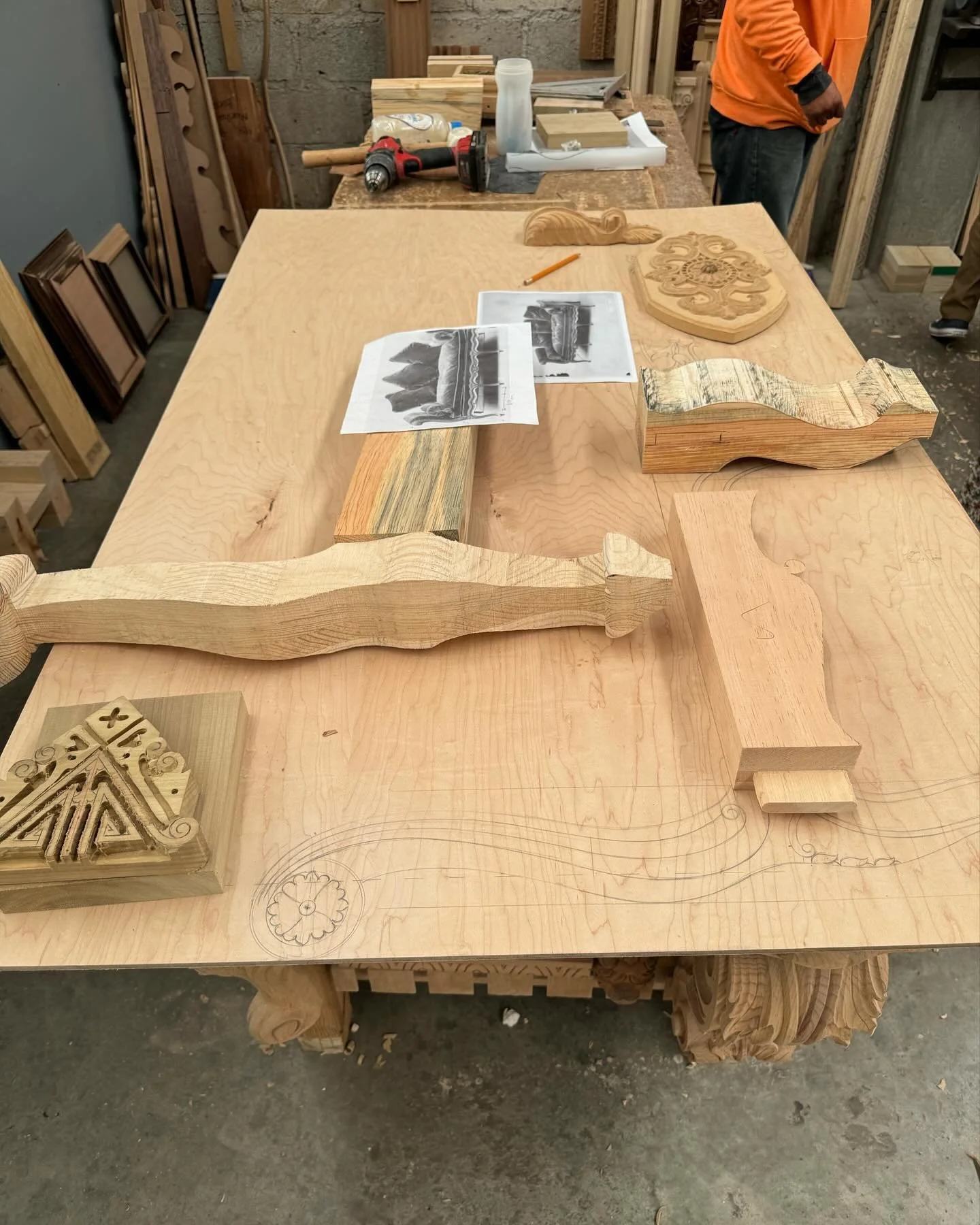 The beginning process of reproducing a Louis XV Chaise Lounge. This shows our scaled hand drawn template, a carving sample and original image.