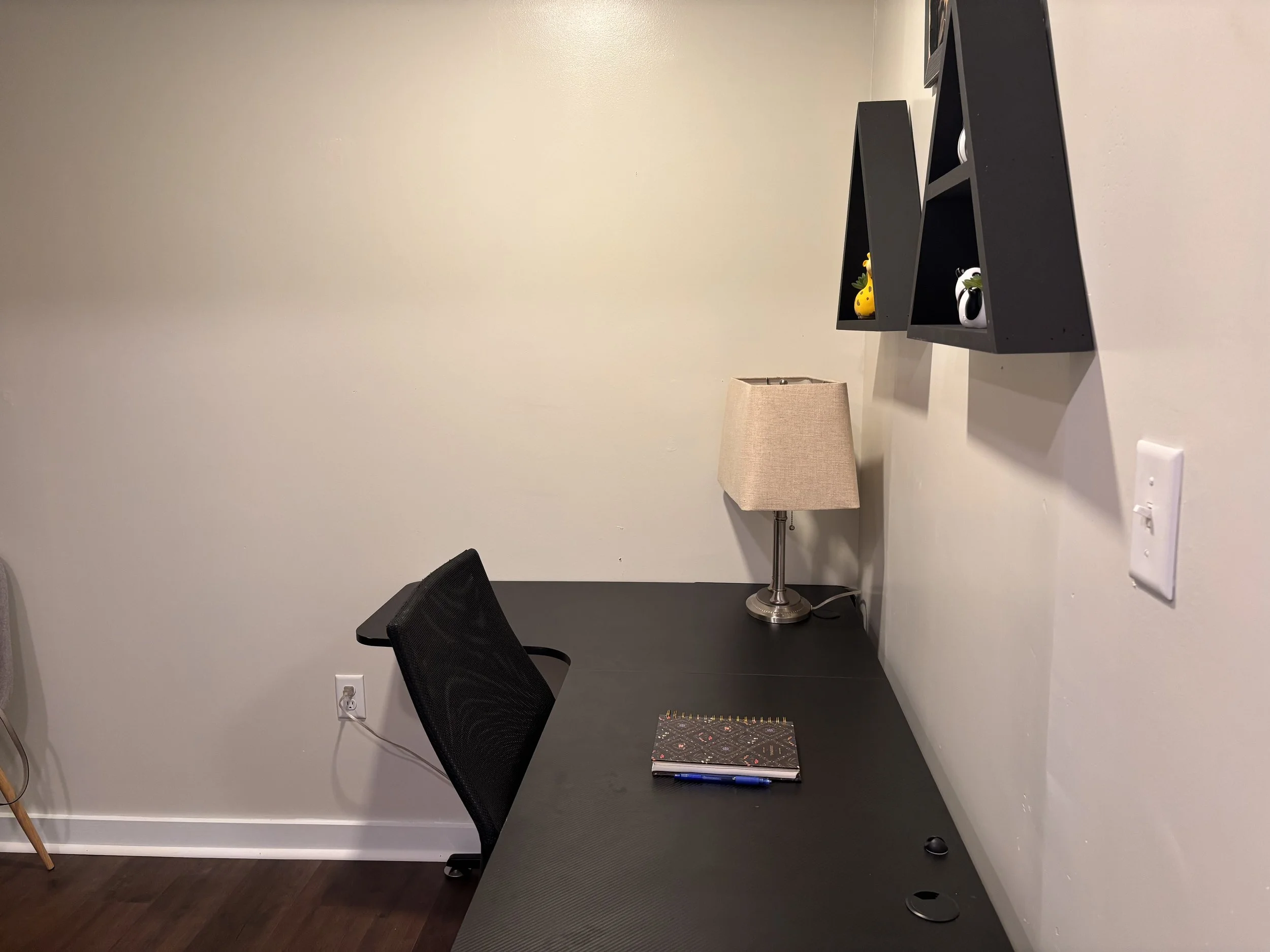 Black desk with white walls
