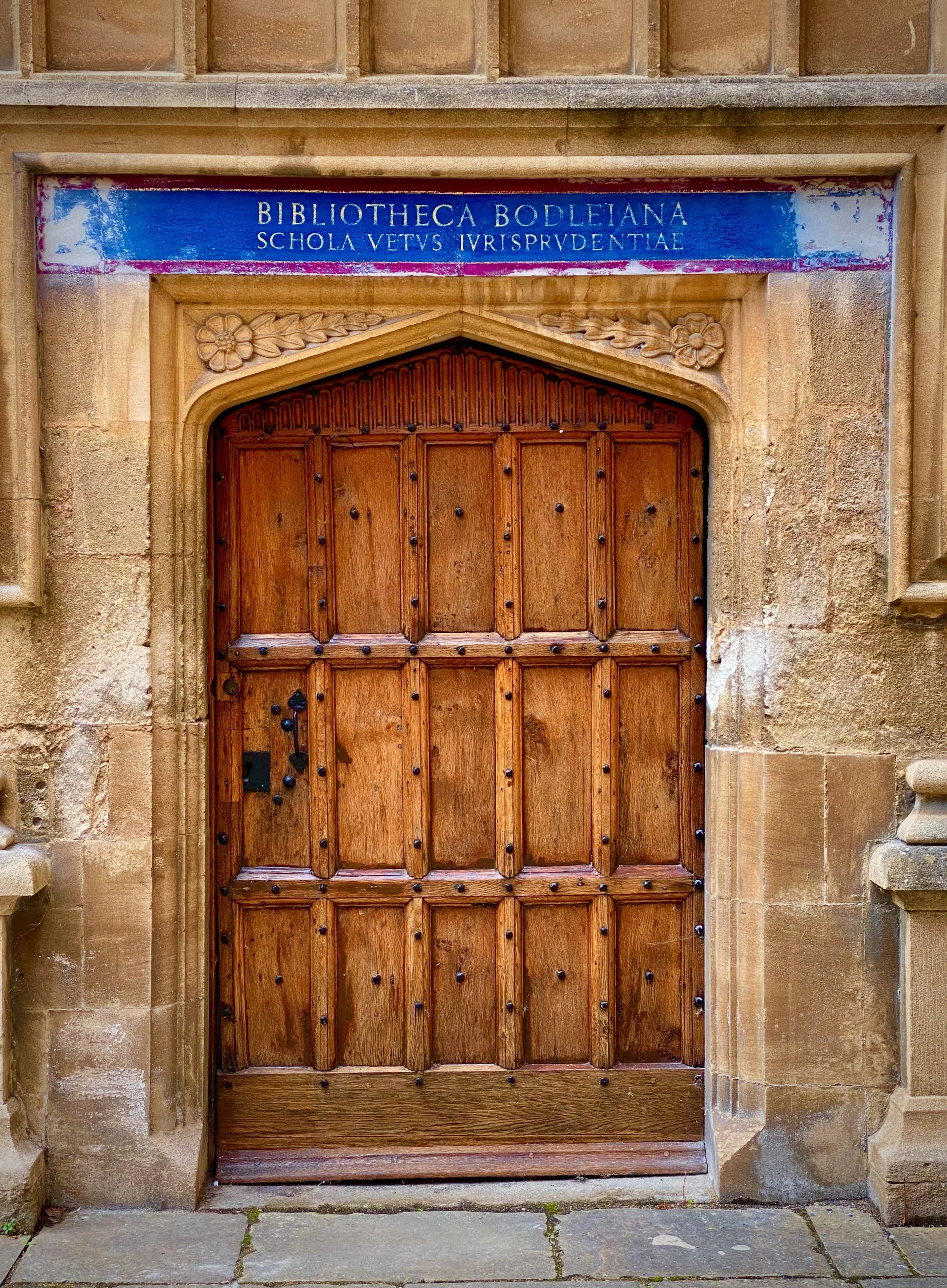 Image of a historic door in the Bodleian library quadrangle which you see on an Oxford University our