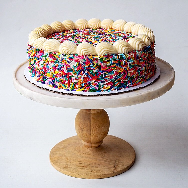Happiness is found in our Rainbow Celebration Cakes! 🎉 Two layers of fluffy vanilla sponge cake, buttercream (chocolate or vanilla!) and a party of crunchy rainbow sprinkles on the outside. This is the kind of cake that makes everyone smile - kids, 