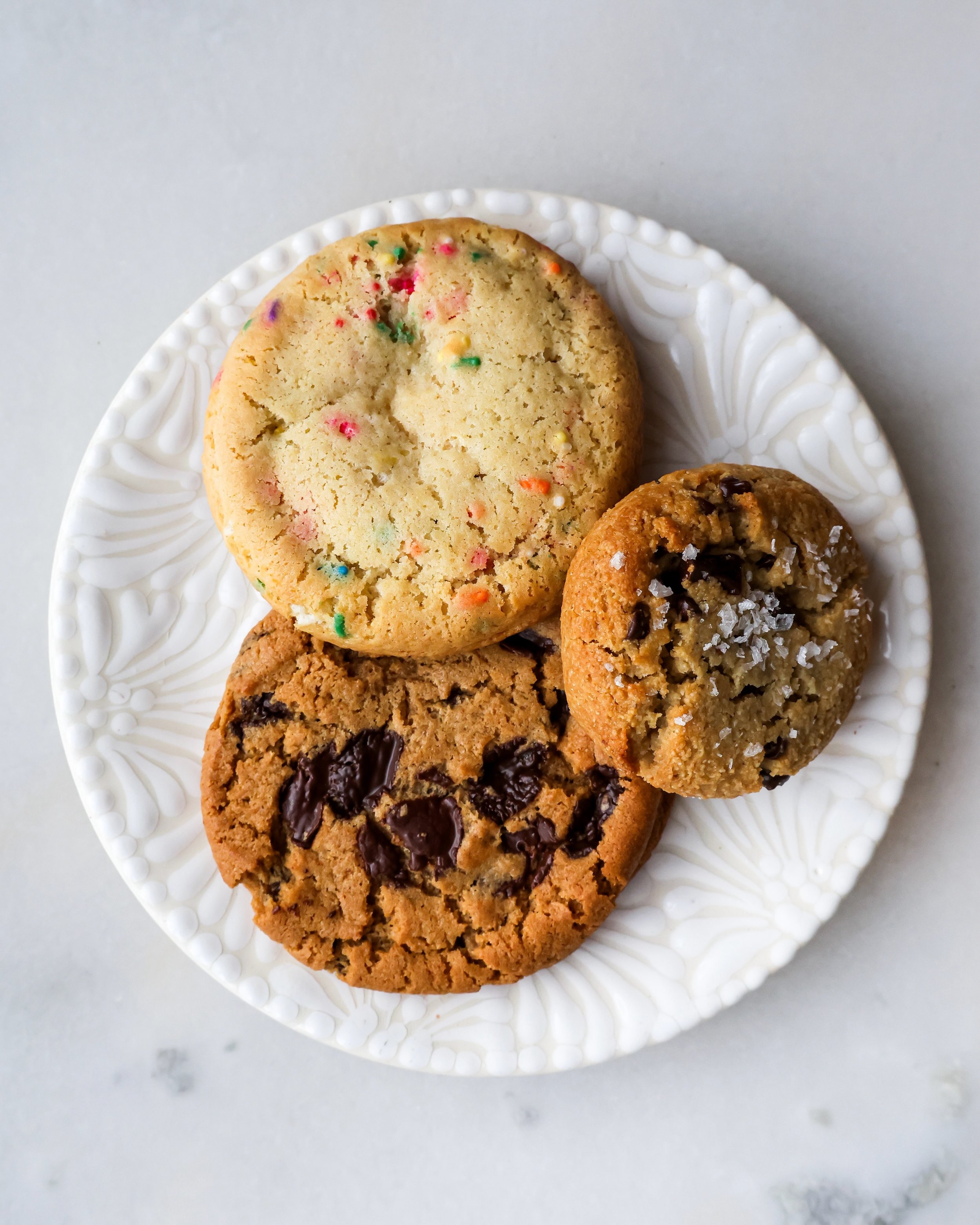 Some of our classic cookies for Memorial Day. Chocolate Chip, Confetti, and Tahini Chocolate Chunk.

We are OPEN regular hours today, so come by our shop in Clinton Hill and get out of the chilly rain for a bit. 🧡#thegoodbatch