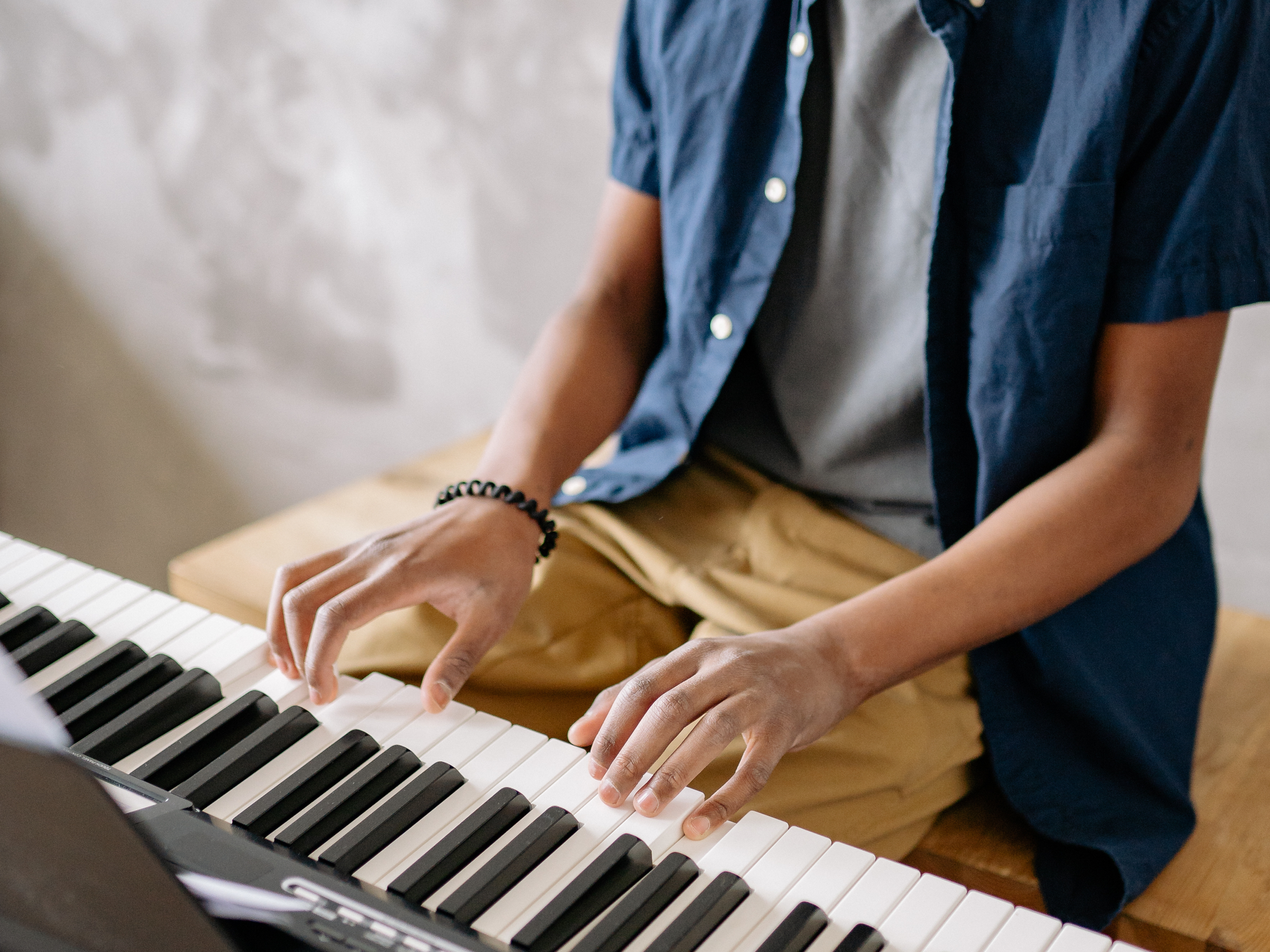 closeup of black boy playing the piano
