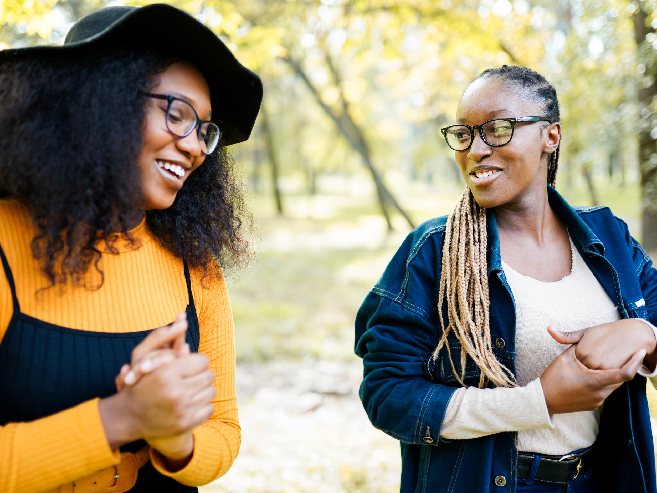 two black women walking outside and talking