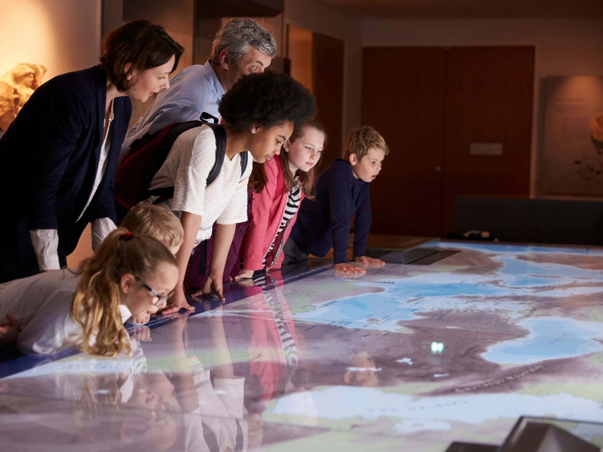 group of kids and adults at a museum