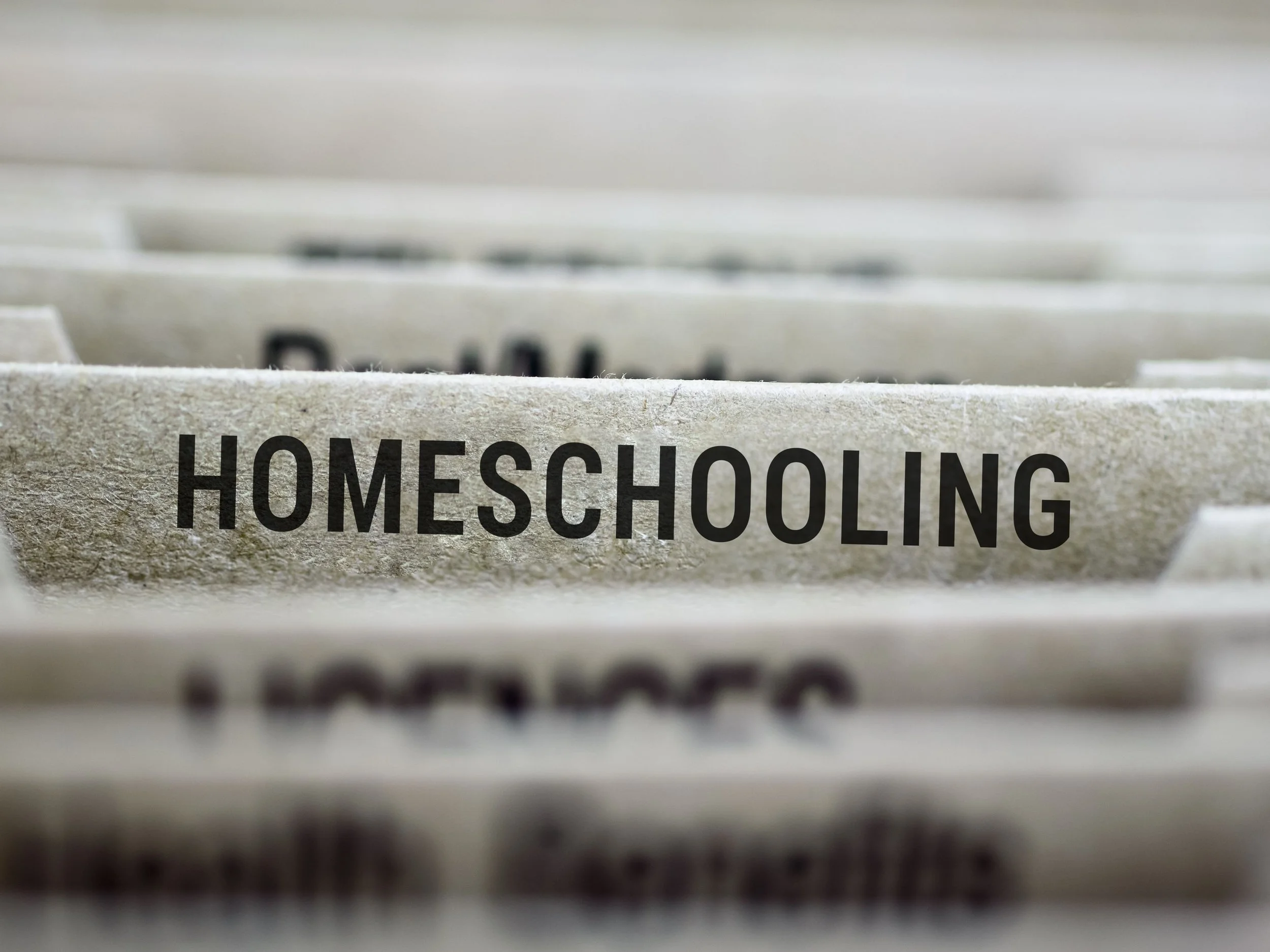 closeup of files and one sticking out that says homeschooling