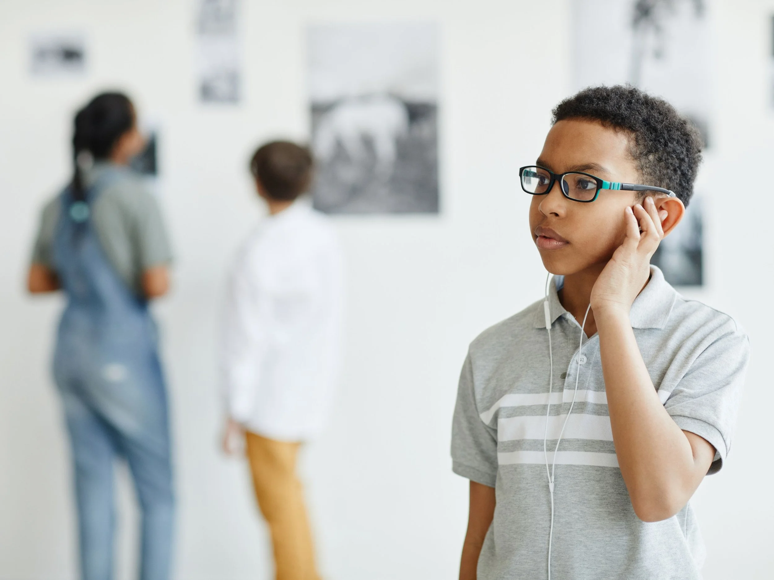 young black boy walking through a museum
