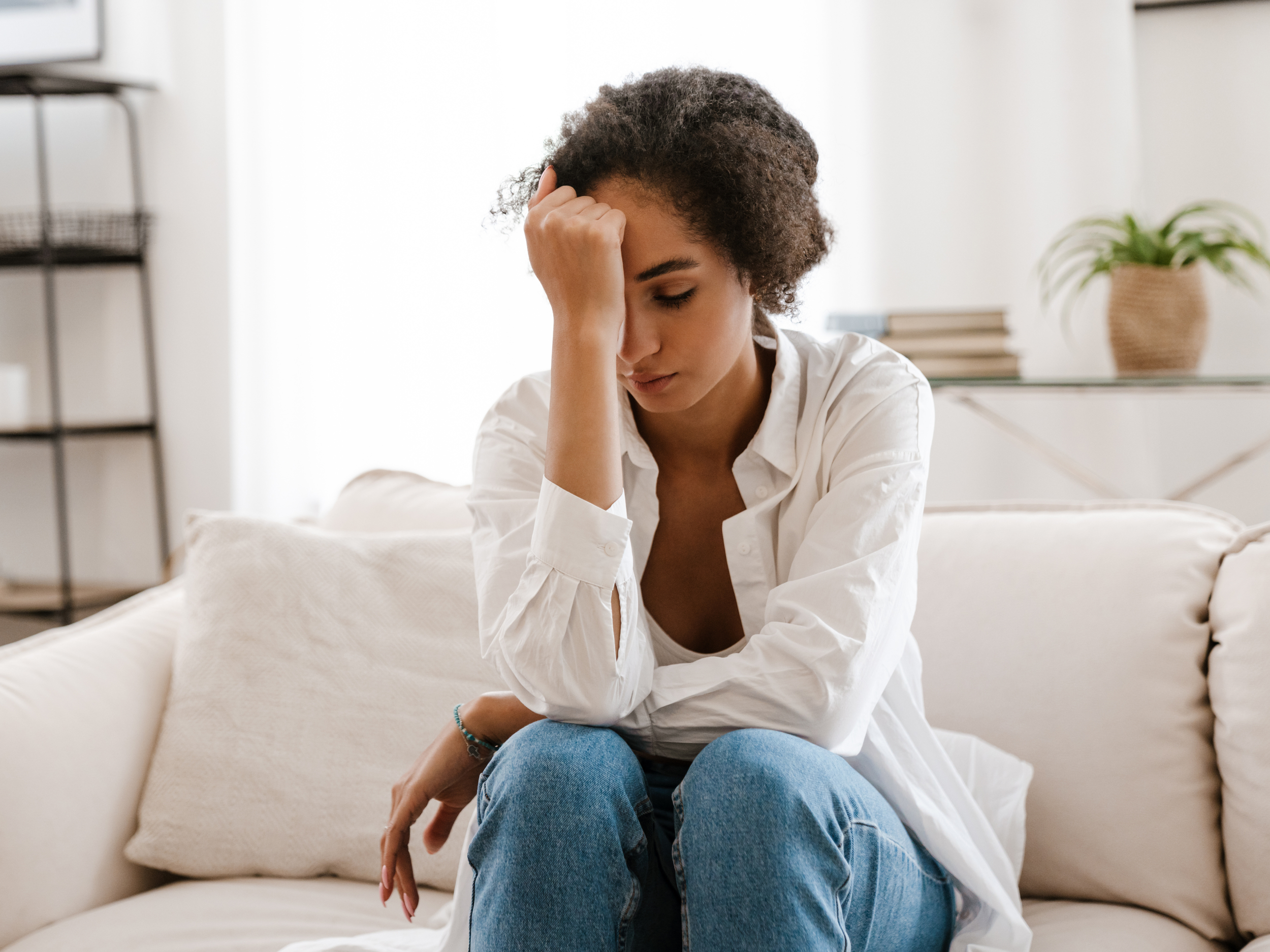 frustrated black woman sitting on couch
