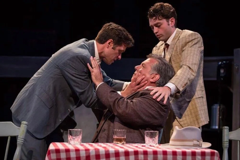Willy Loman and his children having a strained and physical conversation.