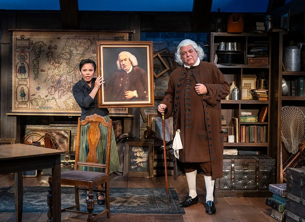 Brian Mani as Samuel Johnson standing beside his portrait.