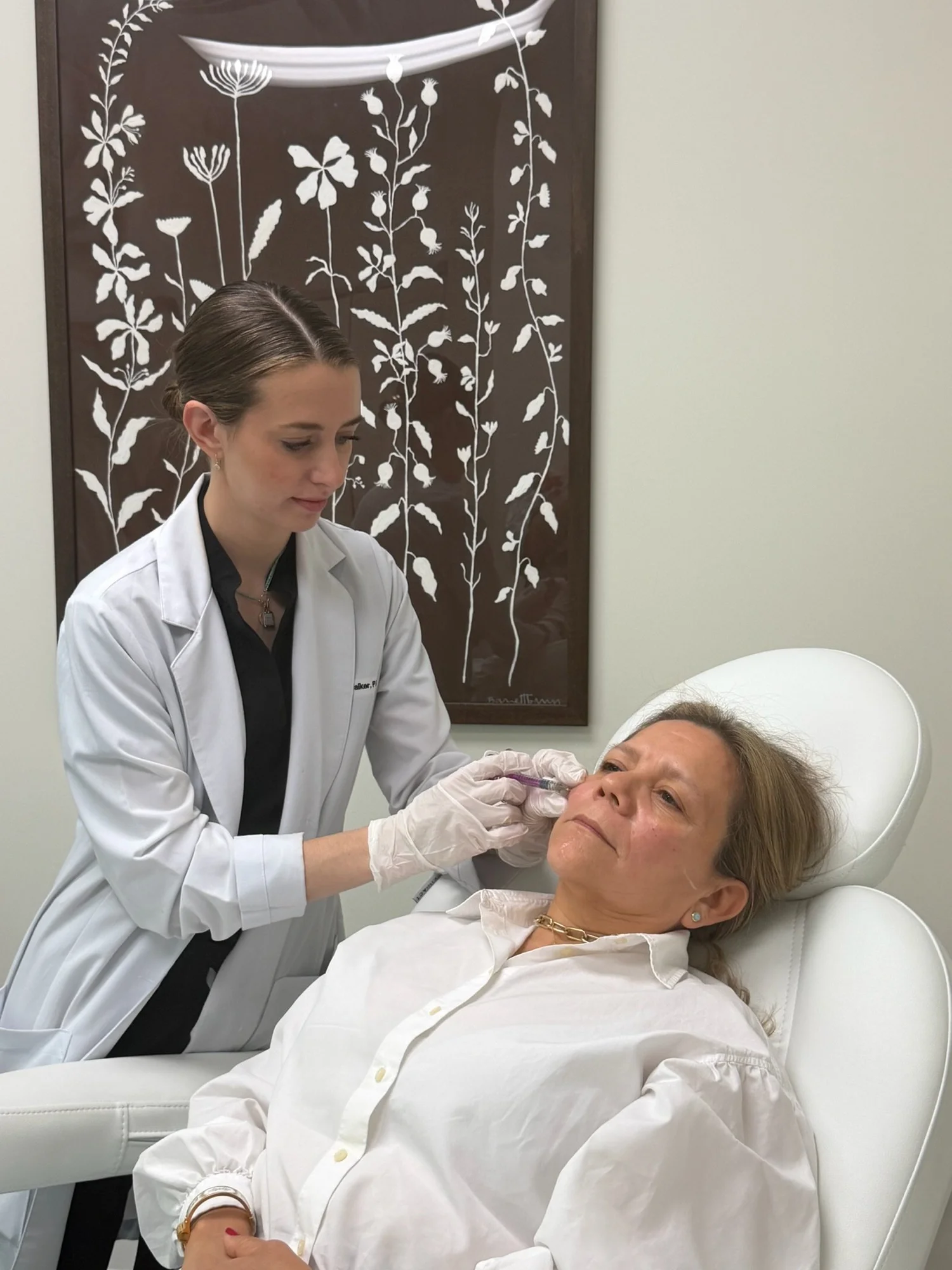 A Skinship provider treating a patient's face in the Buckhead treatment room