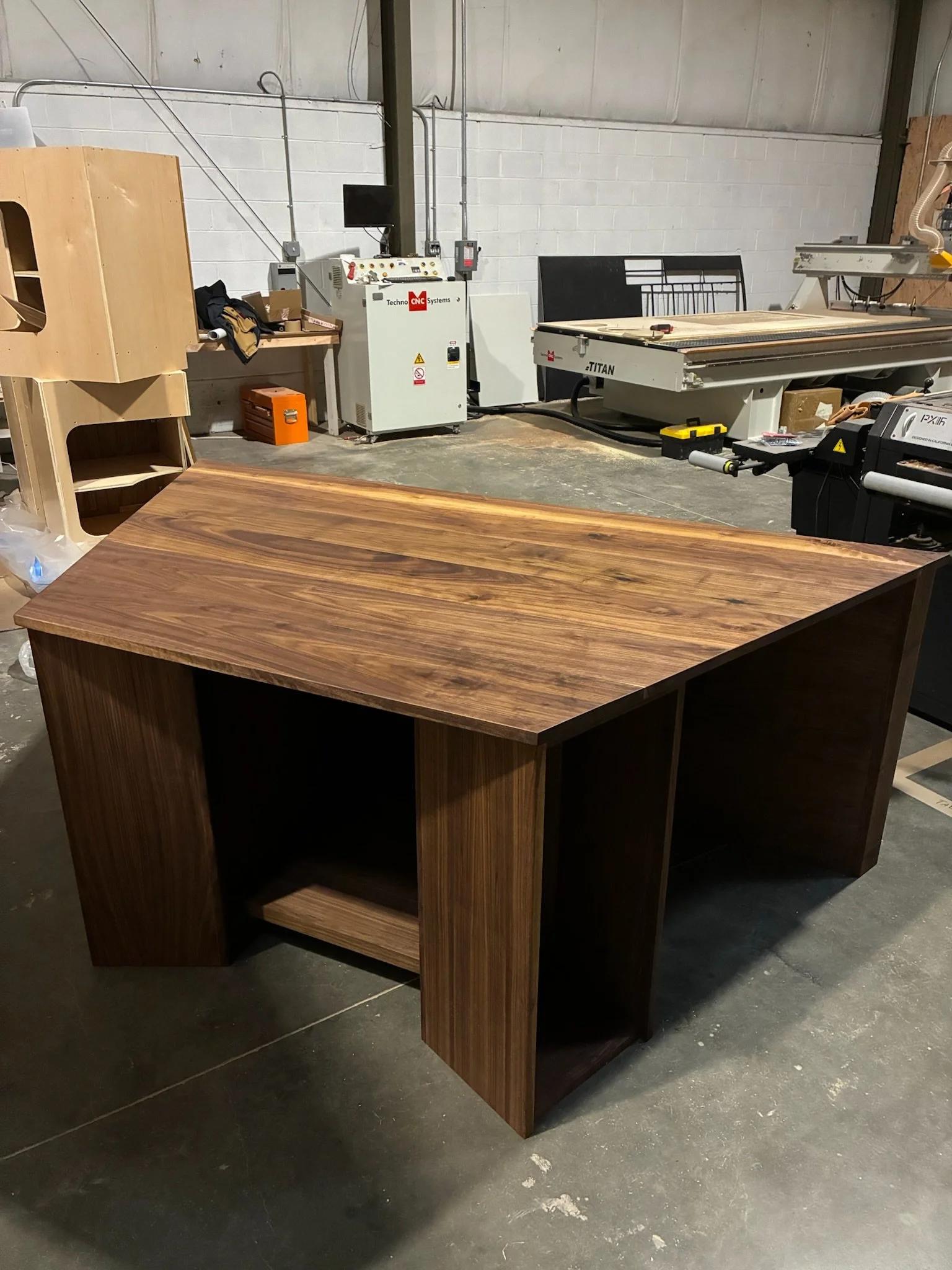 A wooden desk in a woodworking workshop.