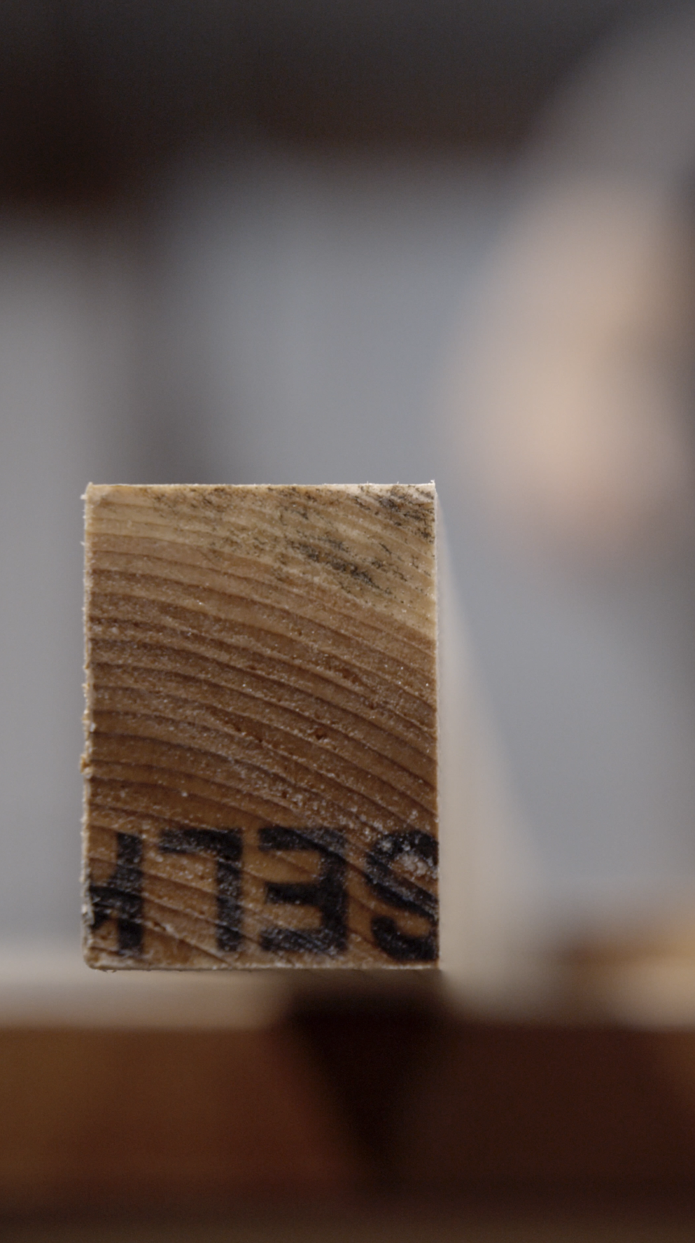 Close-up of a wooden block with the number '1239' printed on the bottom, captured from a low angle.