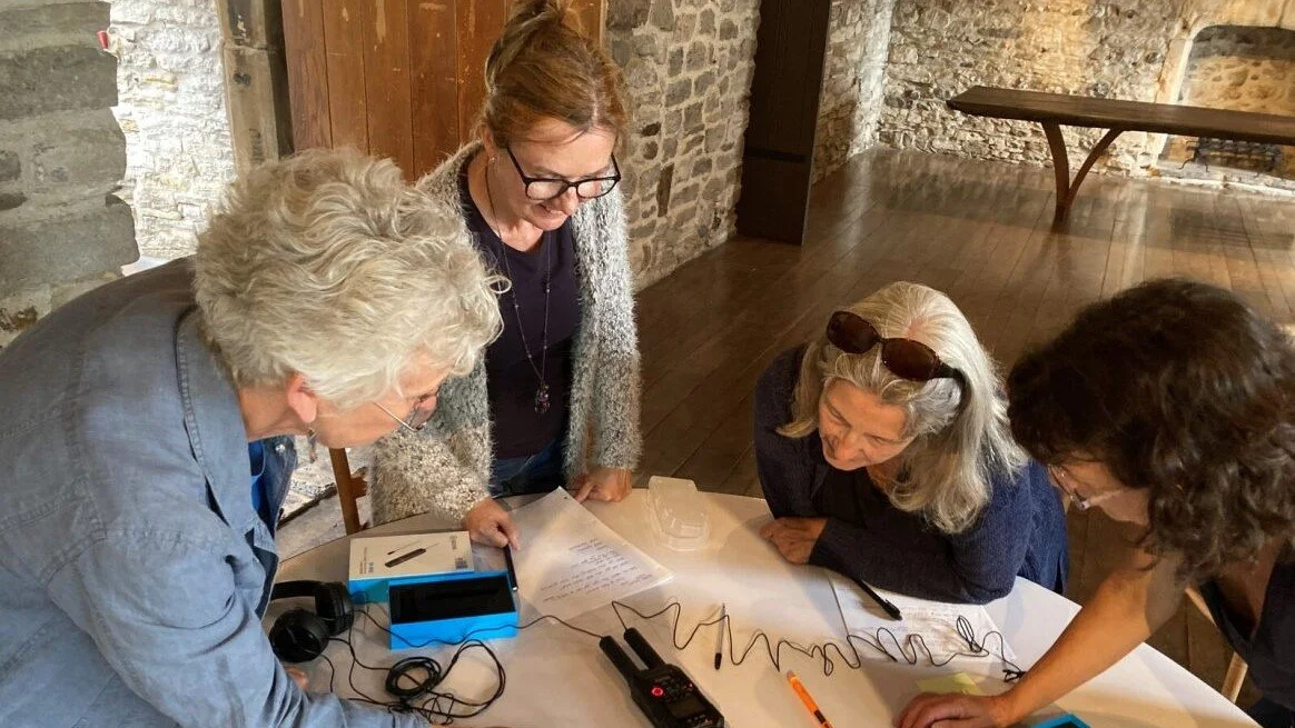 Volunteers at oral history training day look at equipment