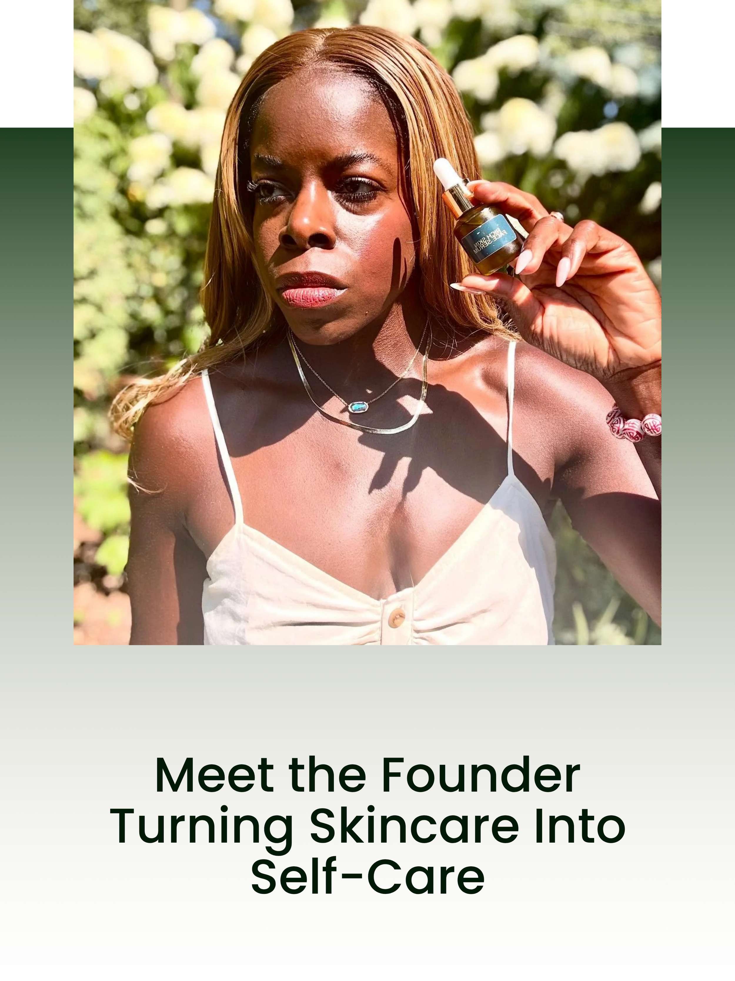 A woman with long, light brown hair holding a small dropper bottle of skincare product outdoors. She is wearing a white sleeveless top, silver jewelry, and standing in front of green foliage.