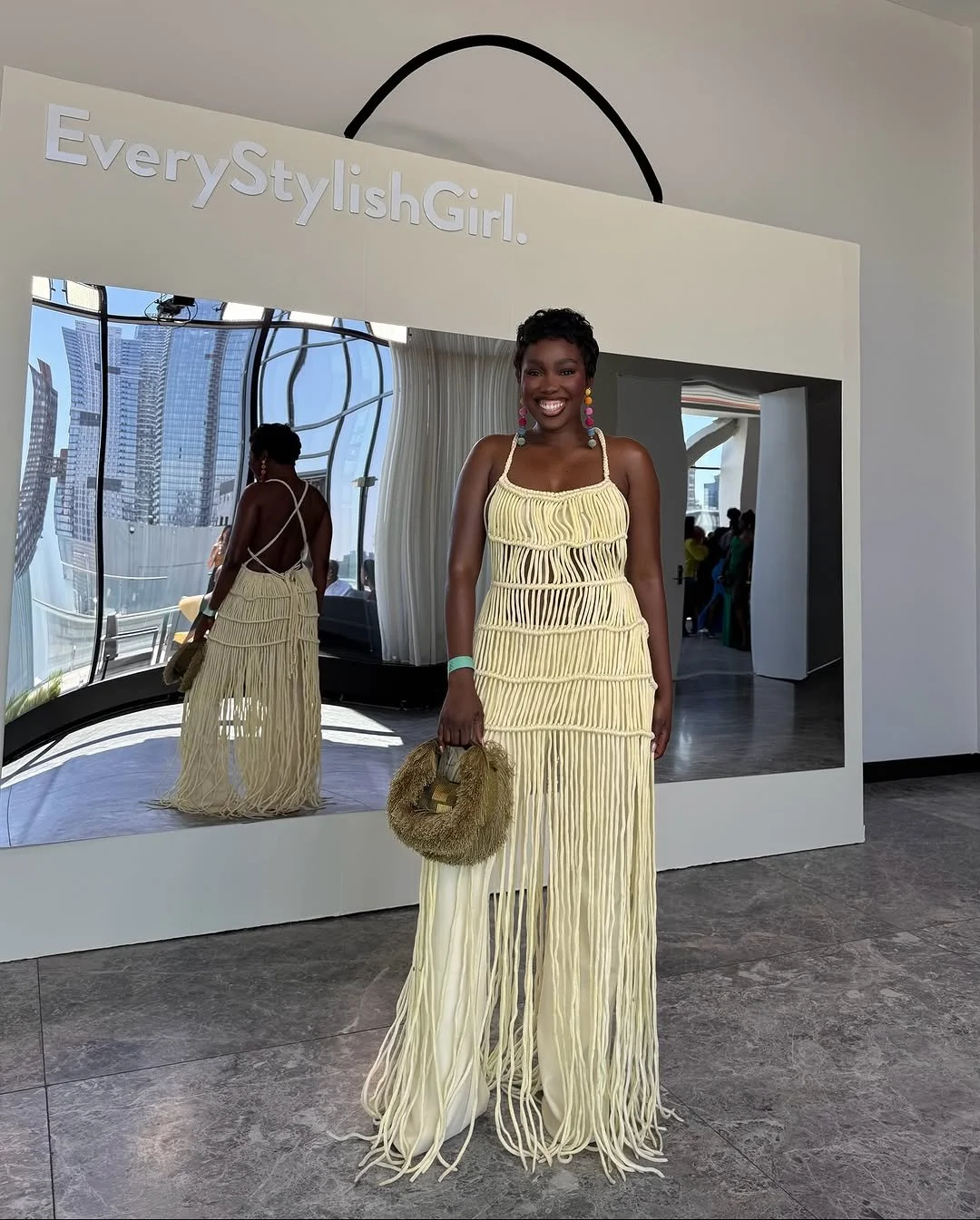 @iamdodos in a qreenade dress and shopkisara bag