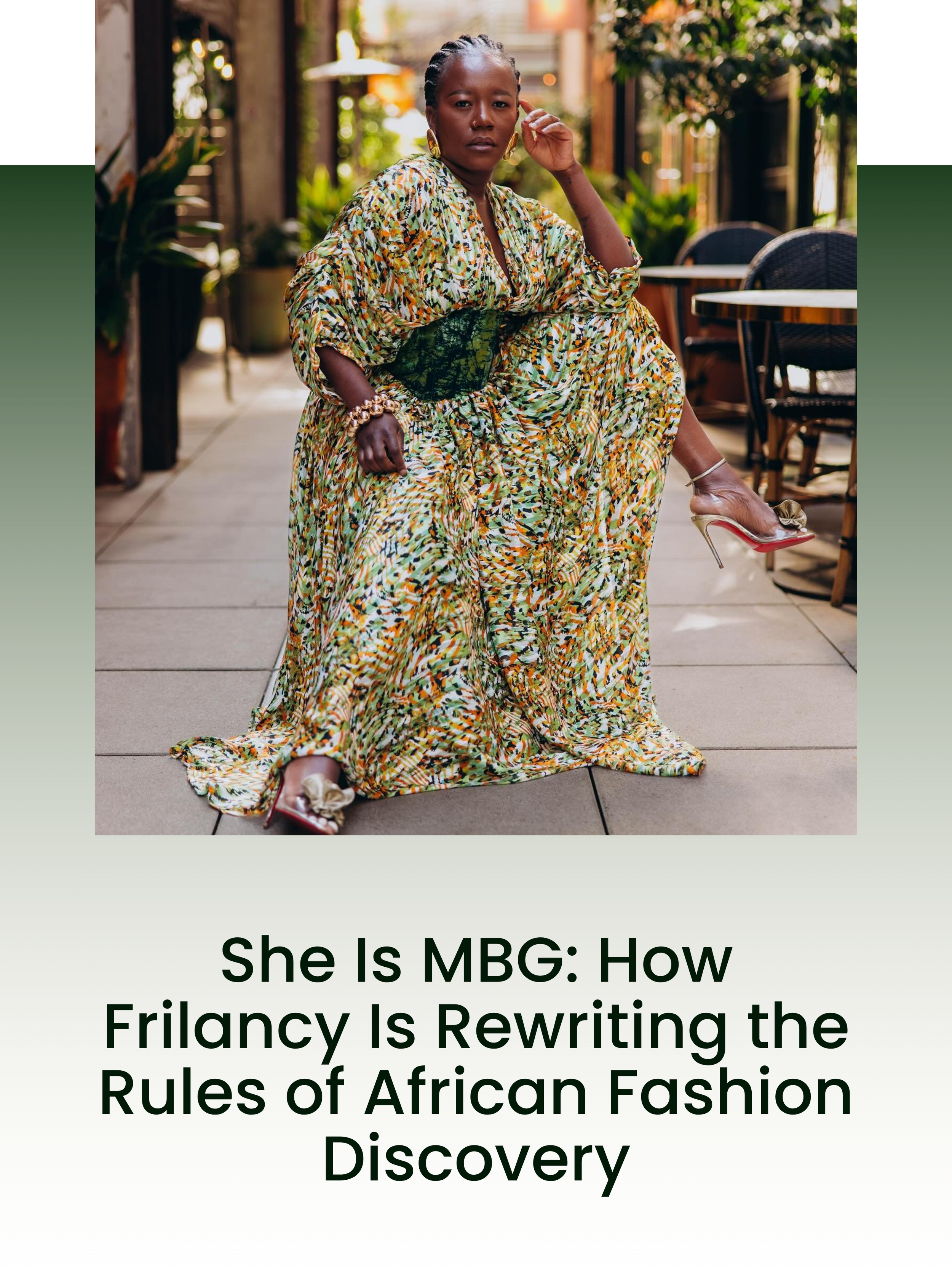 A woman dressed in a colorful, patterned flowing dress sitting confidently on a chair, in an outdoor cafe setting with greenery and tables around her.