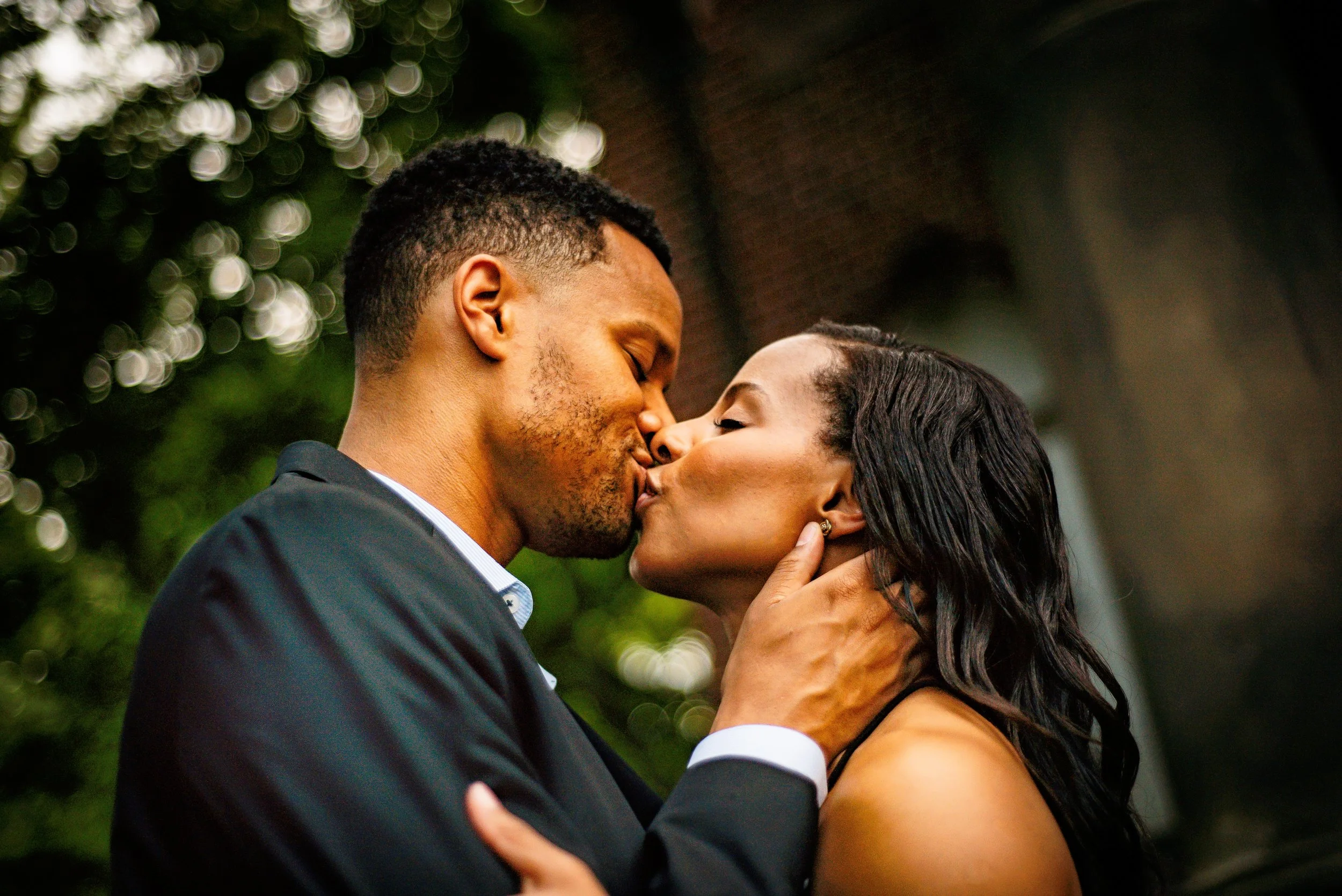 Romantic Austin engagement photo of couple kissing in elegant garden setting