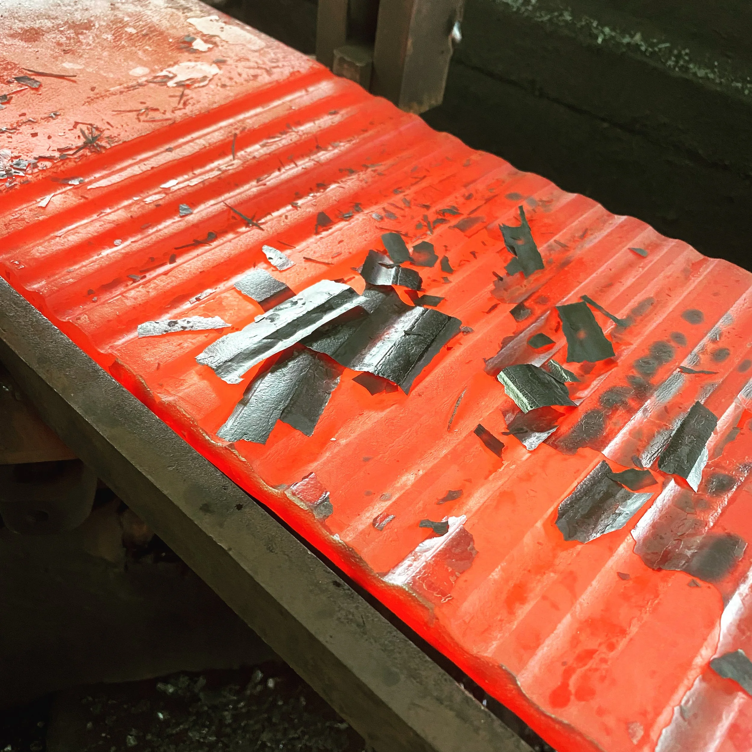 Hot textured steel plate being hand forged for a bespoke metal staircase