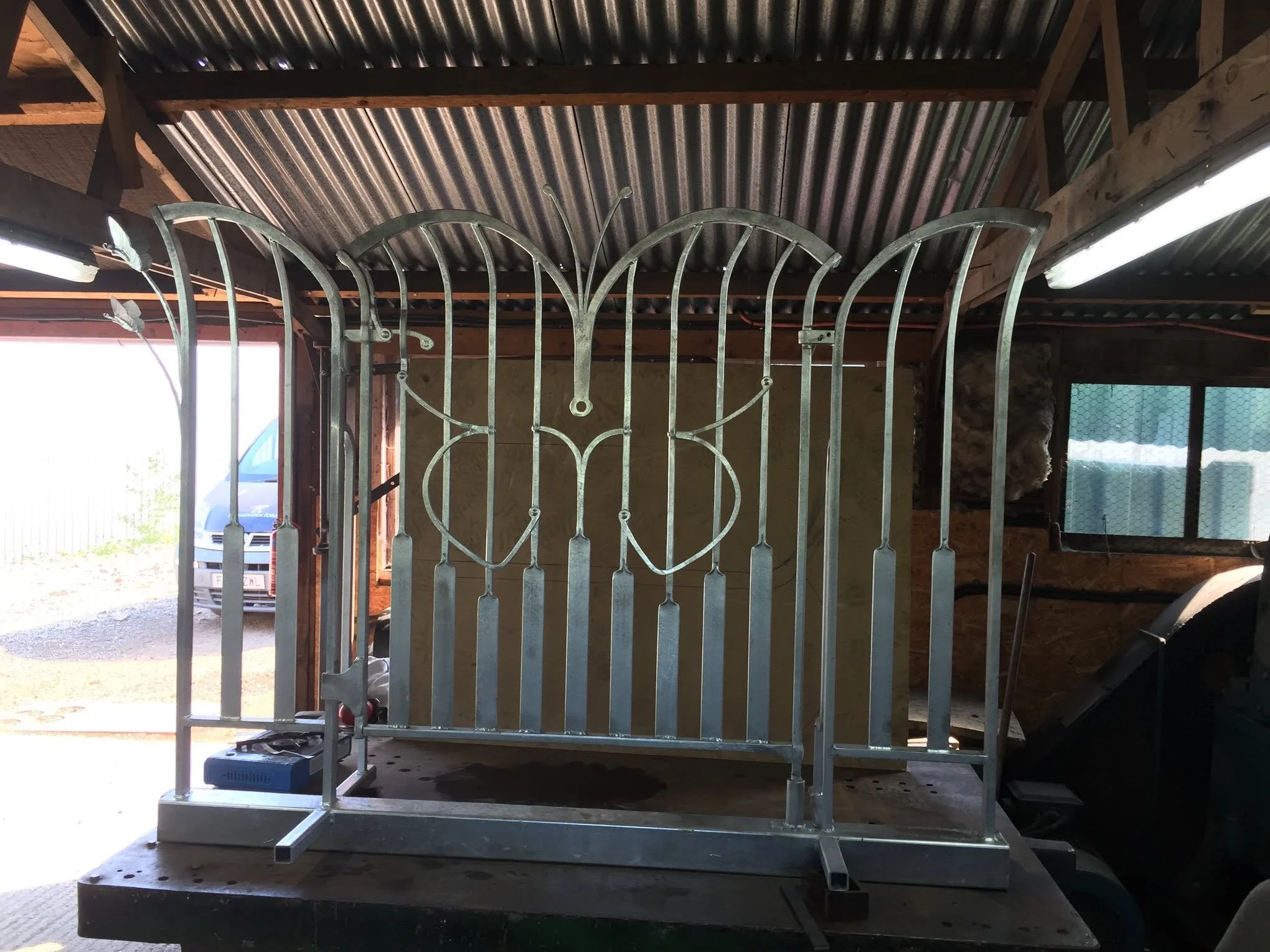 Bespoke steel nature reserve gate during fabrication in the blacksmithing workshop