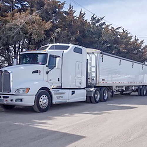 White trucking hauling hopper Freight 