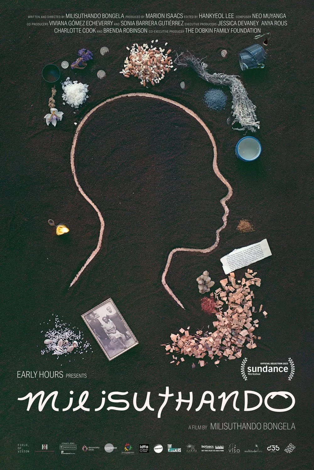 A black poster with a light pink chalk drawn profile of a person in the center, surrounded by dried flowers, herbs, colored sand, a ripped book page, and a small black-and-white family portrait. White lettering say "Milisuthando" at the bottom.