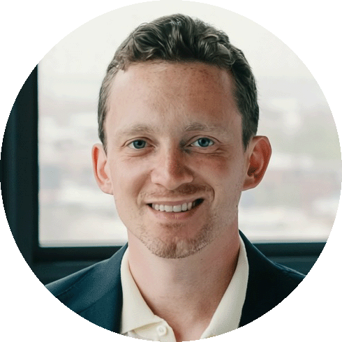 Jesse is a white man, smiling, with short hair and a dark teal blazer.