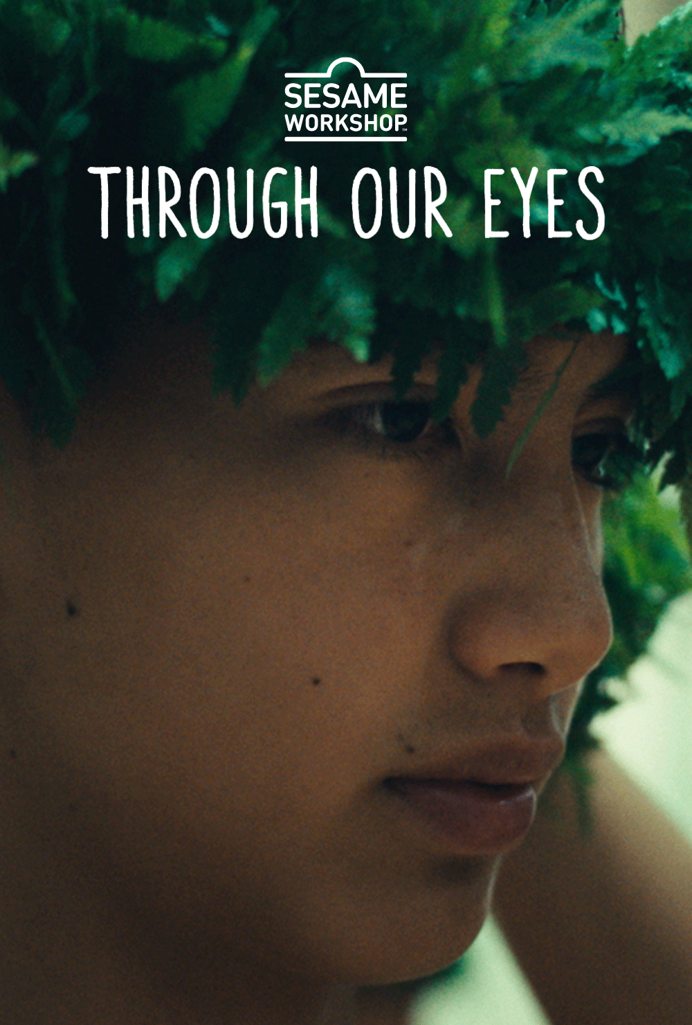 Film poster for Through our Eyes that shows a close-up of young Hawaiian boy with brown eyes and a leafy green headpiece on, in profile.