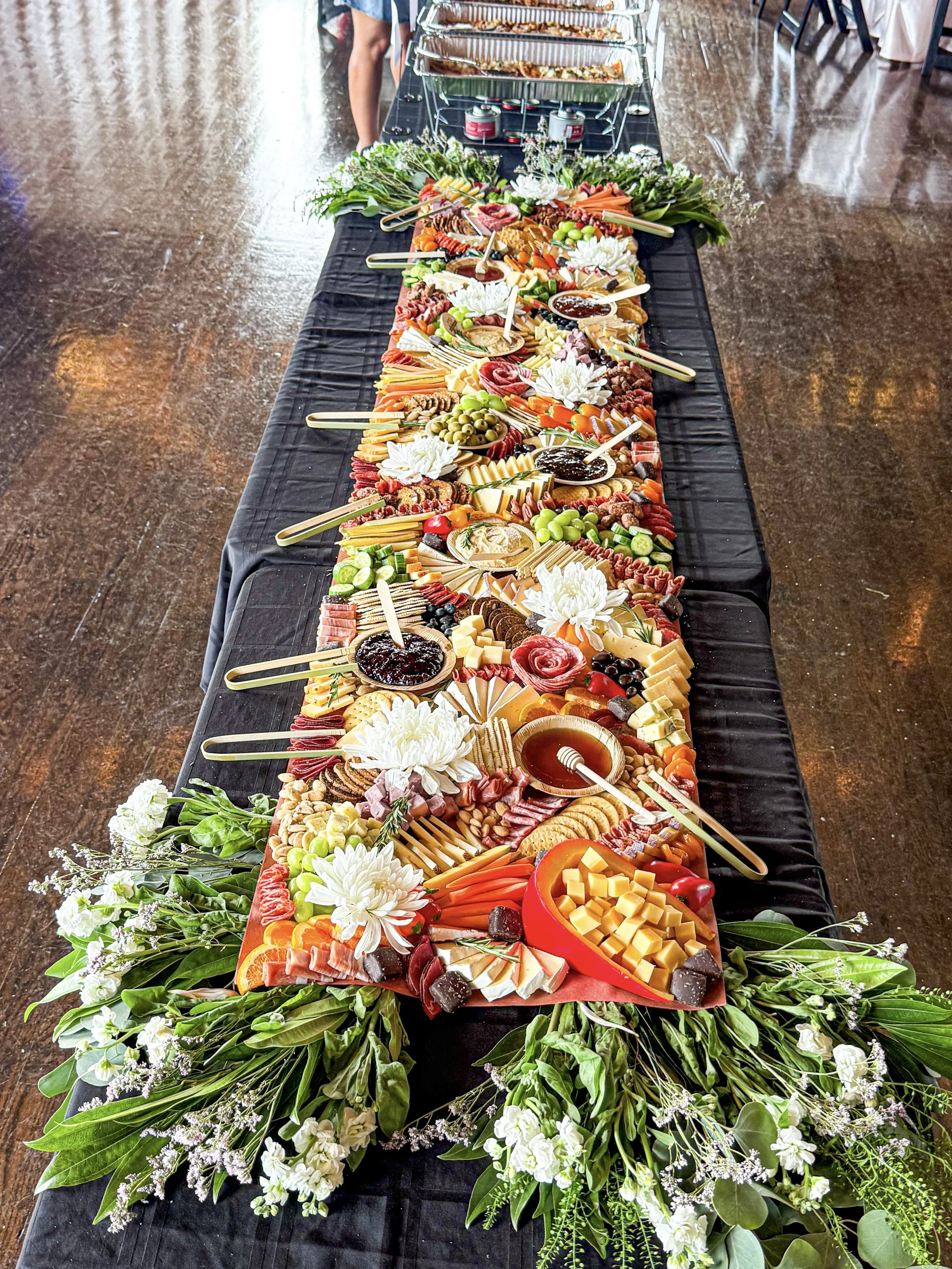 70 person charcuterie flat lay grazing table for a non-profit 35th anniversary