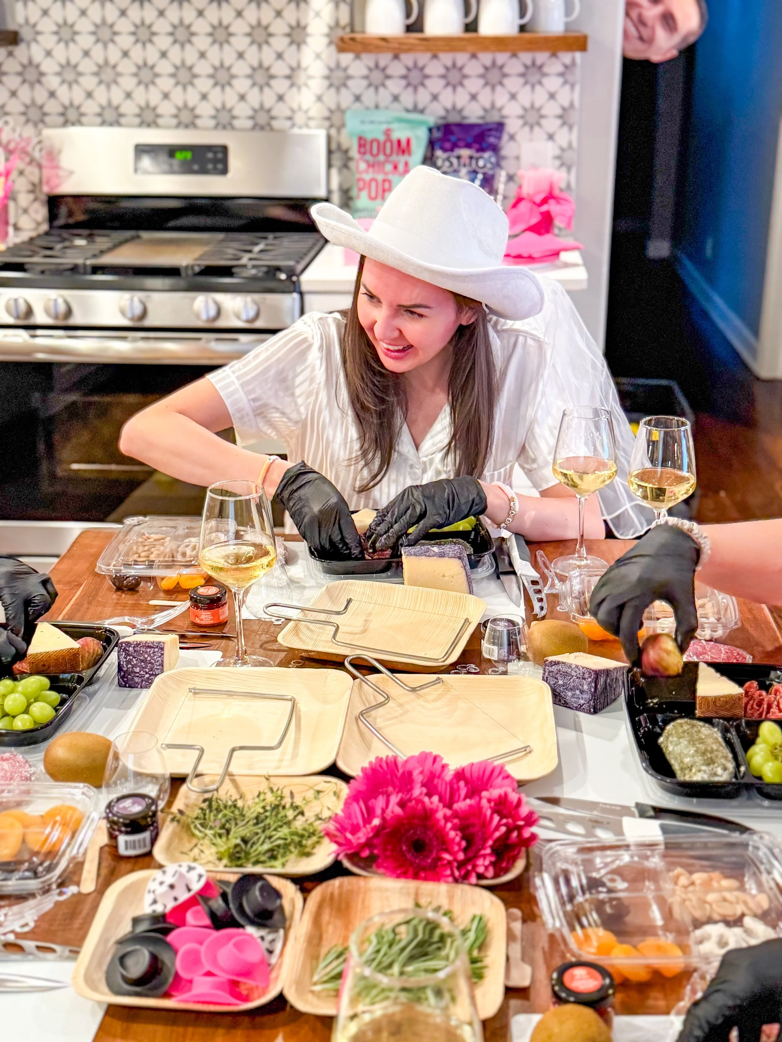 A bride in Nashville at her airbnb making a charcuterie board