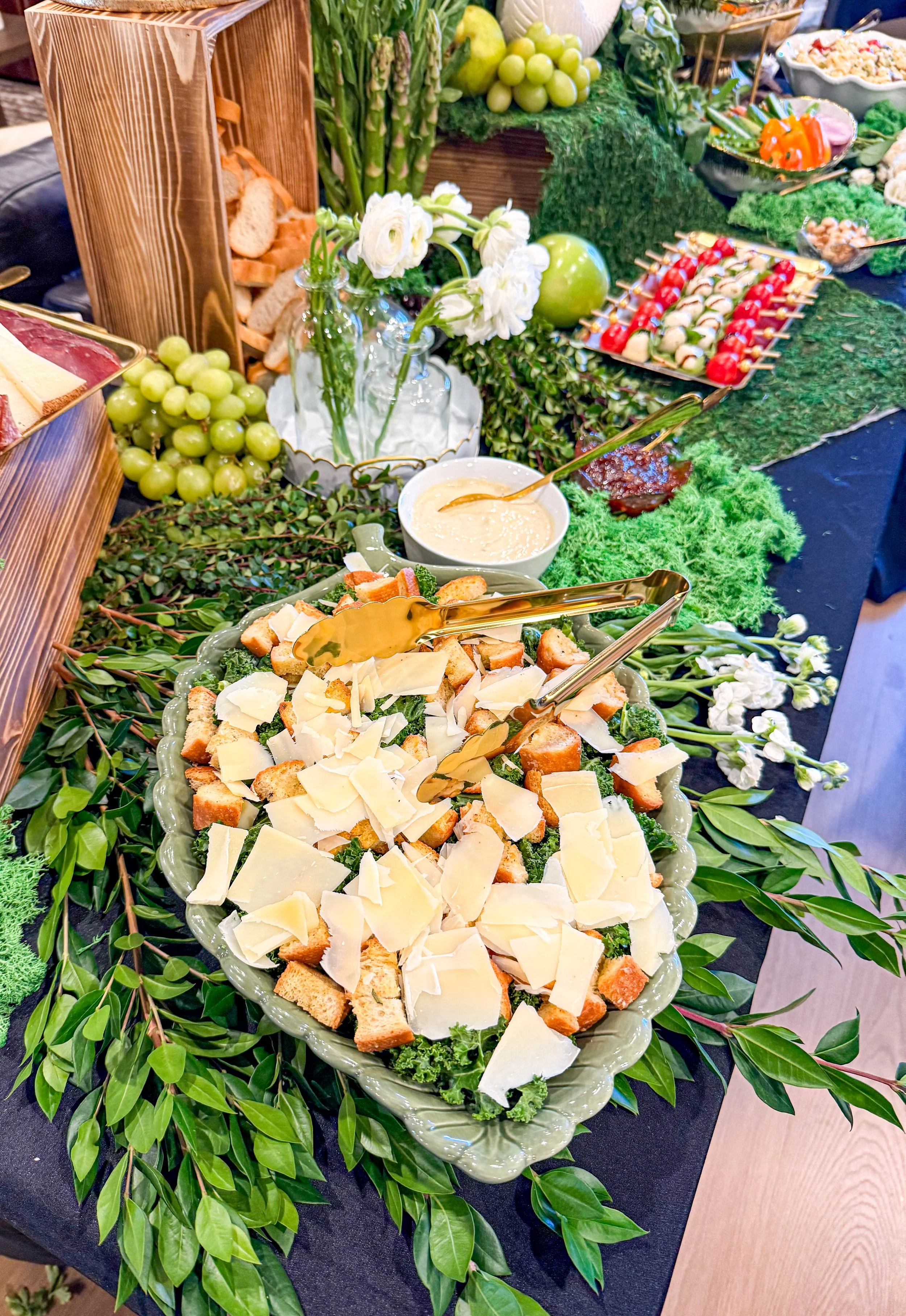 Grazing table with Caesar salad and caprese skewers