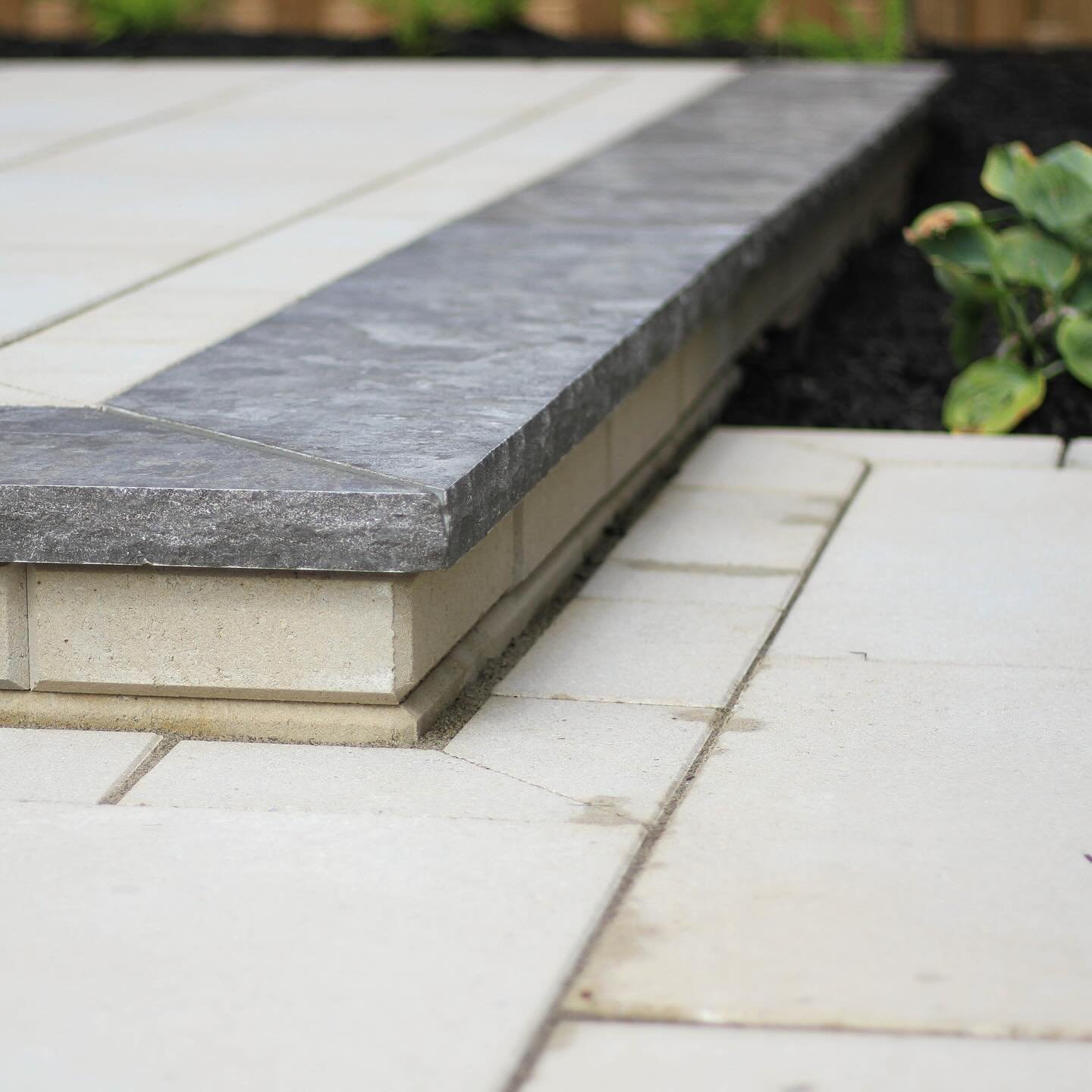 A study in sleek design.
&mdash;
Antique Black is a natural grey limestone mottled with dark, contemplative colours and a rich array of textures. This stone effortlessly enhances its surroundings, becoming a standout element of any landscape design.
