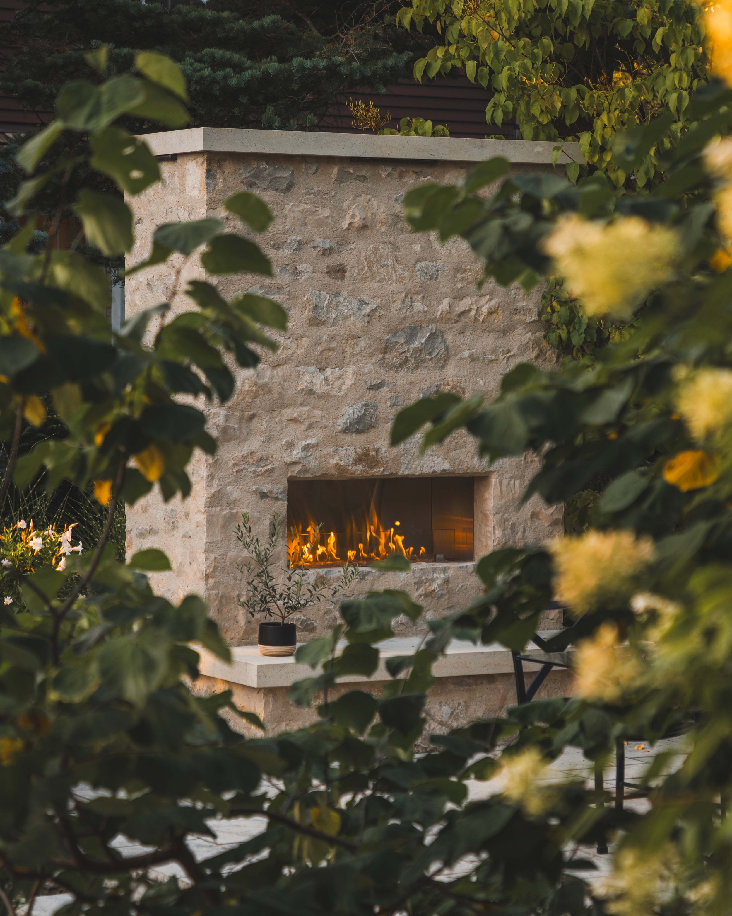 Natural stone veneer fireplace on an outdoor patio