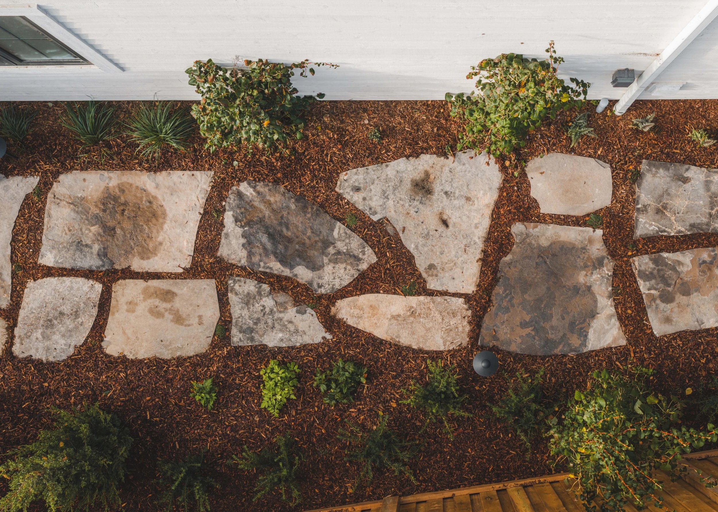 Natural stone flagstone path surrounded by auburn mulch