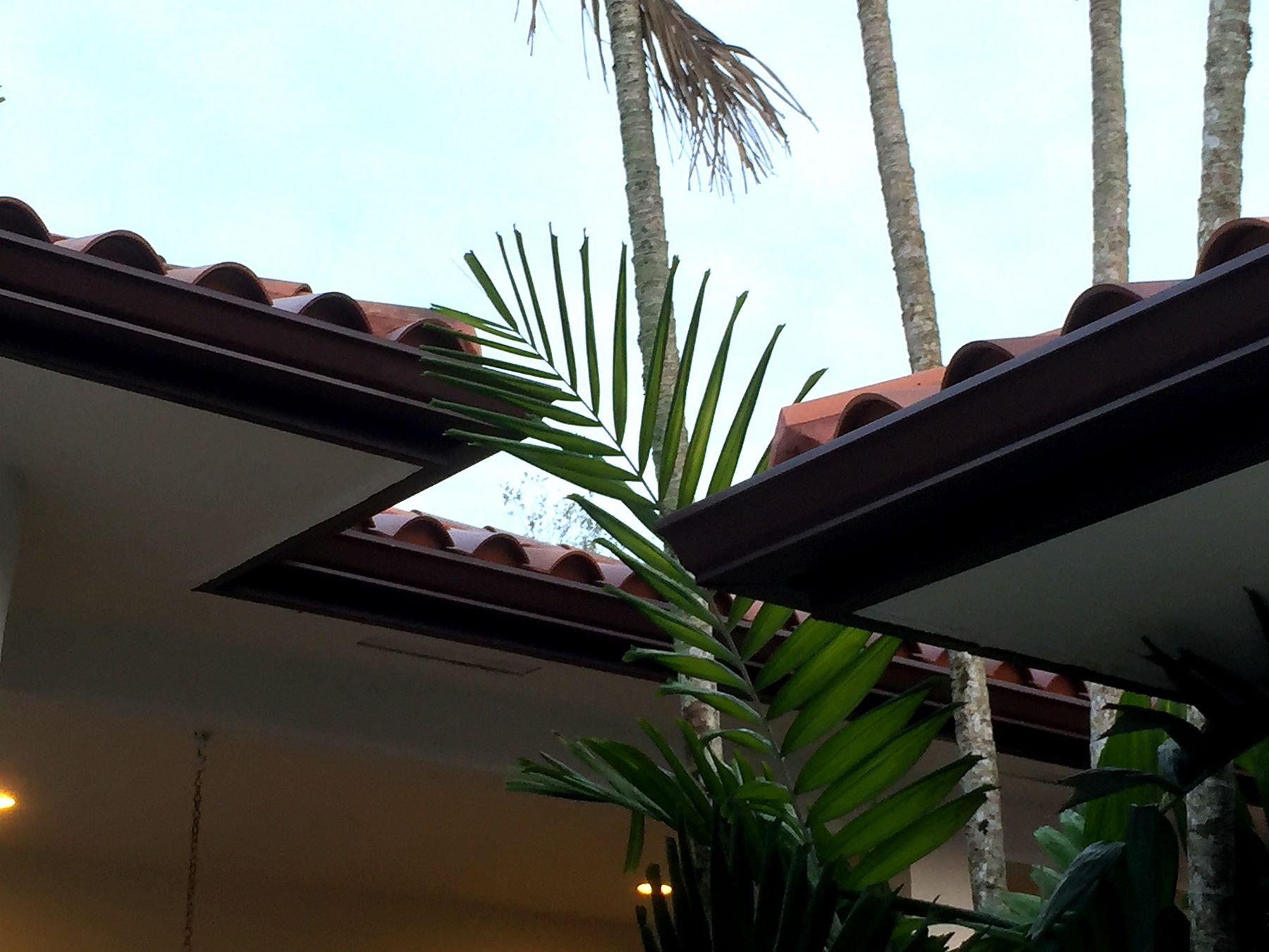 Seamless gutter installation on a tile-roof home in Key Biscayne, Florida