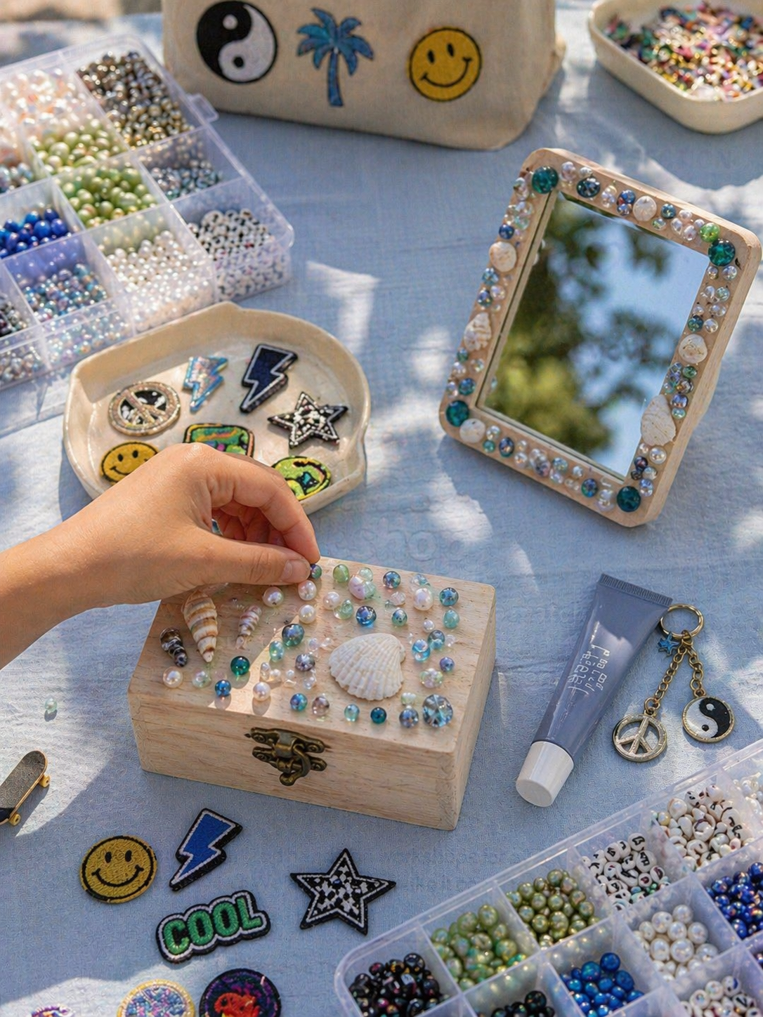 An open wooden treasure box with a brass latch, seashells, and pearls, with text overlay about designing a sea-themed treasure box with items for a mirror.