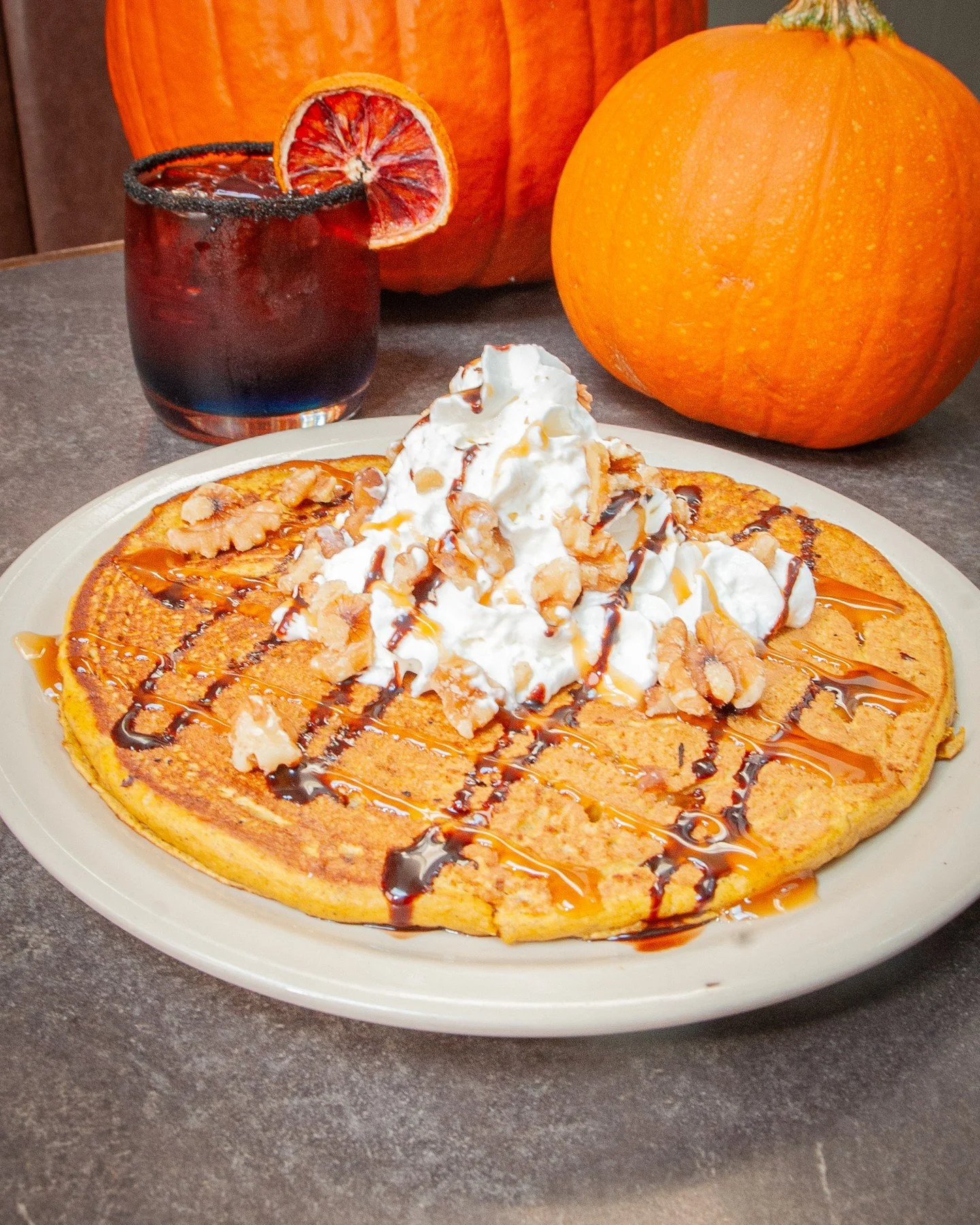 Hey ghouls, goblins, witches, and wandering spirits! 👻 Creep on in and check out our Halloween specials! 
🎃 Pumpkin Pancakes: Whipped cream, walnuts, and chocolate-caramel drizzle. Available only on Halloween day.
🔮 Midnight Eclipse: Gin, bl