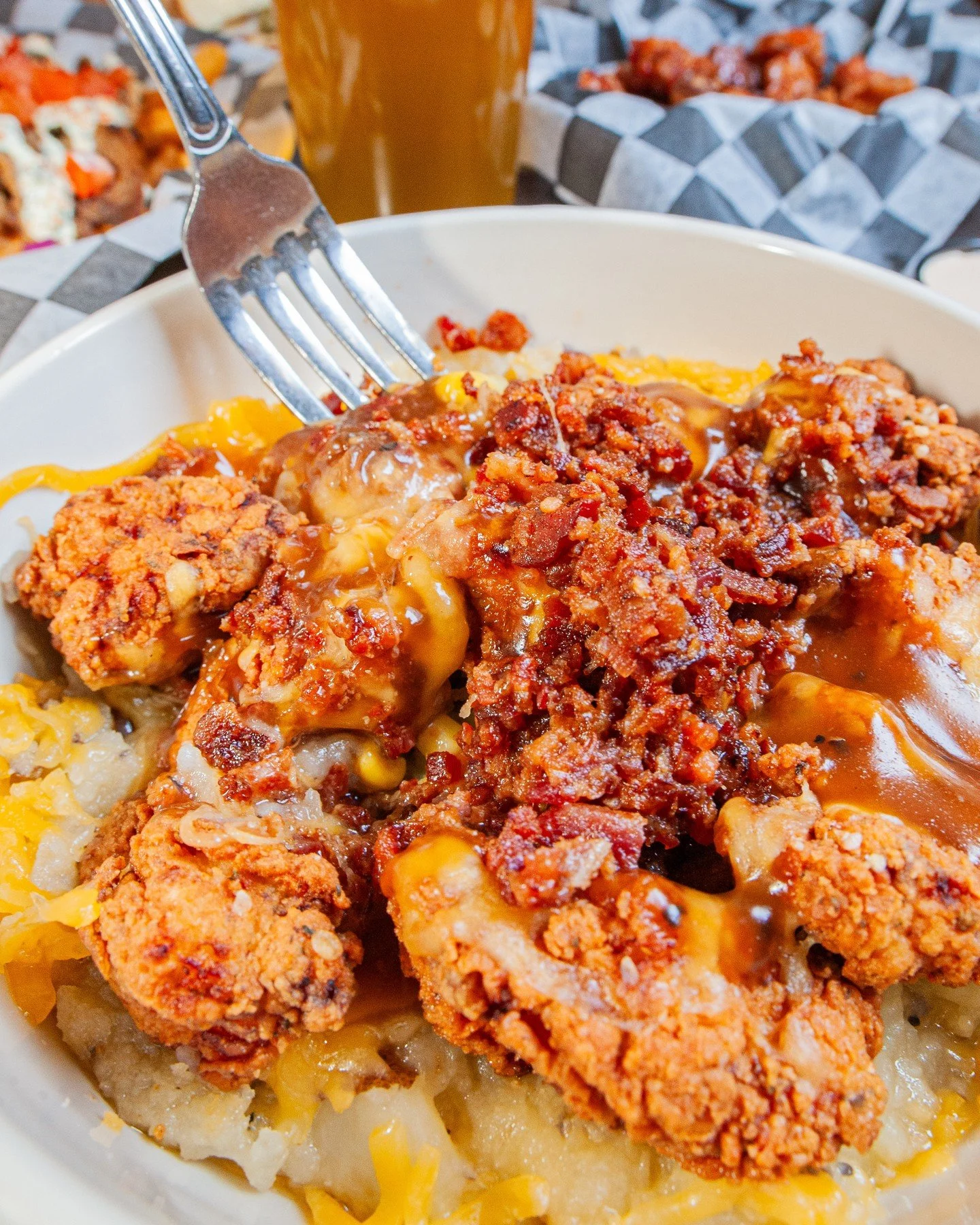 Dig in to our NEW Fried Chicken Skillet! 🍴🍗🥔🎉⁠
⁠
Mashed potatoes piled high with corn, bacon bits, cheddar cheese, and buttermilk fried chicken bites, topped with your choice of brown or country gravy. This delicious heap of comfort food heaven w