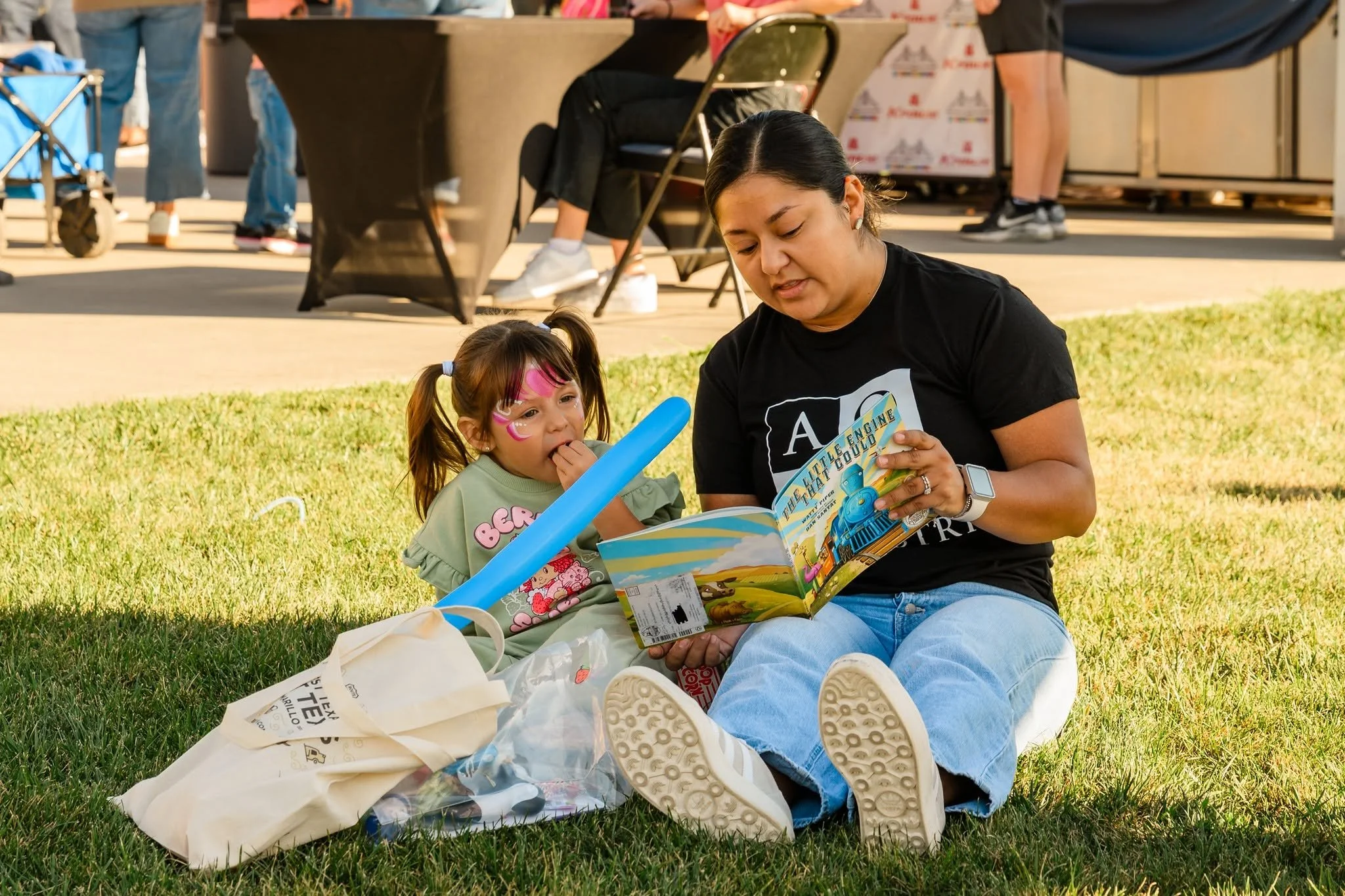live 2025 mom reading grass.jpg