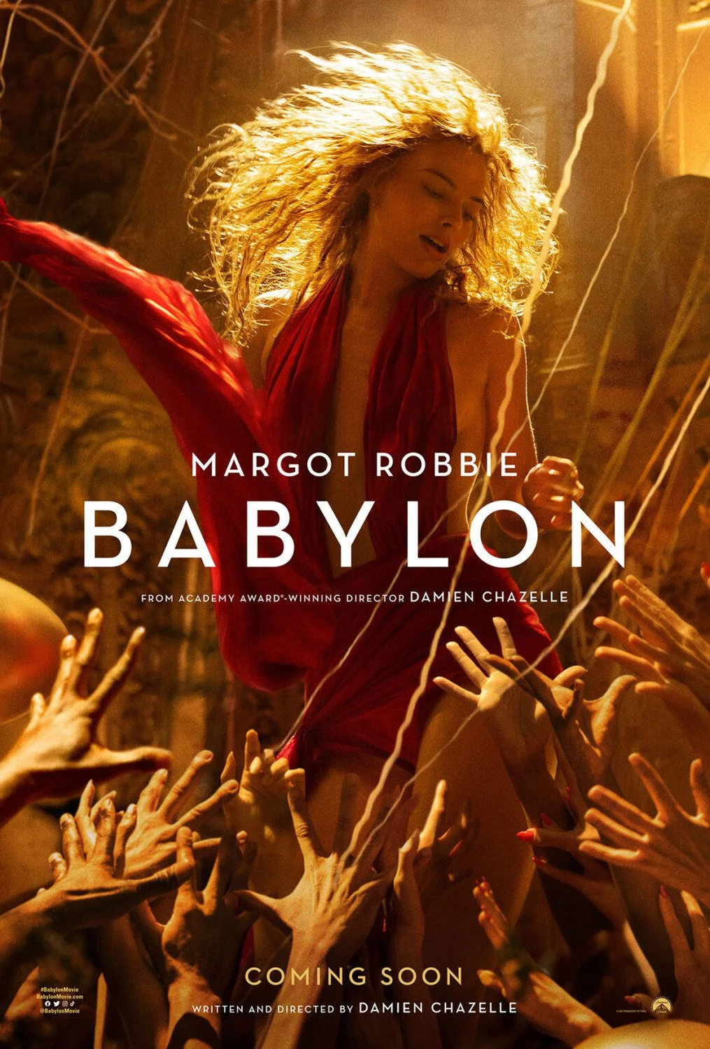 Poster for the movie Babylon featuring Margot Robbie with flowing blonde hair in a red dress surrounded by multiple reaching hands.