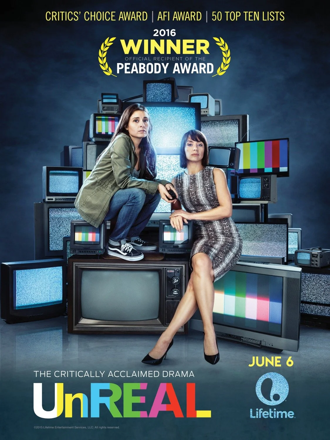 Poster for the TV show "UnREAL" featuring two women sitting on a pile of old television sets, some displaying static or color bars. The show is promoted as premiering June 6 on Lifetime and is described as "The critically acclaimed drama." The background is dark blue with yellow and white text highlighting awards and recognition.