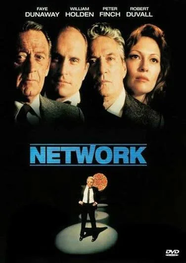 Poster for the movie 'Network' featuring close-up of four main characters' faces at the top and a small figure of a man standing on a stage with a large flower behind him at the bottom.