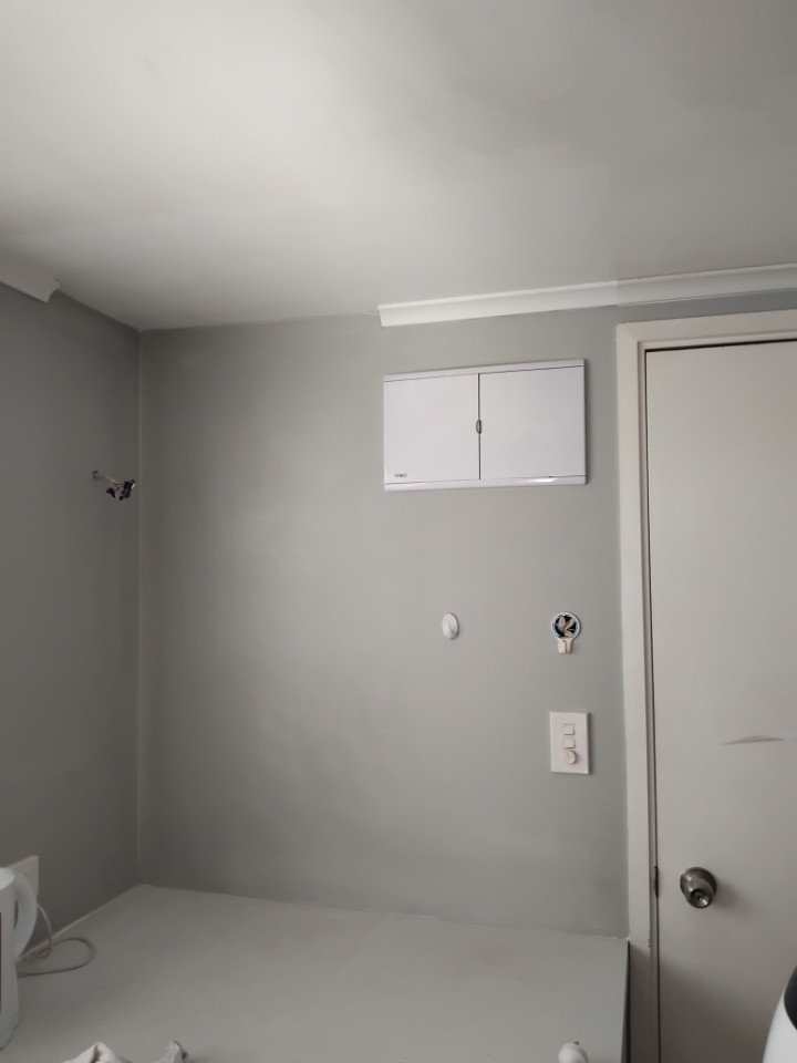 Second coat of plaster, paint matched to rest of wall to minimize cost to property owner