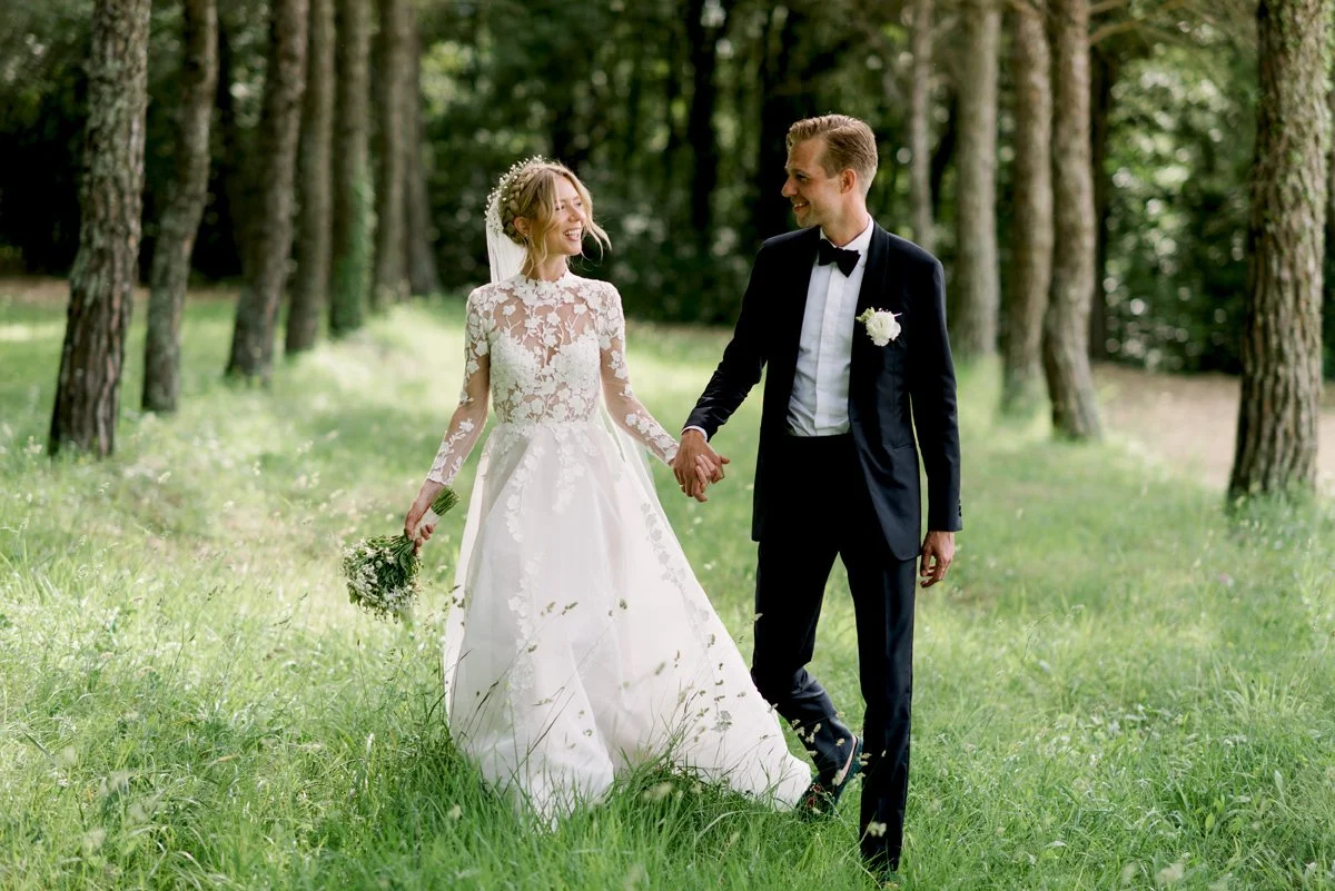 Elegant bride and groom walking hand in hand at Villa Catignano in Tuscany a loving moment captured by FunkyBird Photography and beautifully planned by our wedding planning team in Italy.