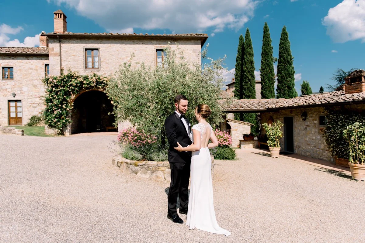 First look between bride and groom in the courtyard of Castello di Spaltenna  an intimate and emotional elopement moment in Tuscany at 5 start hotel beautifully planned by FunkyBird Weddings.