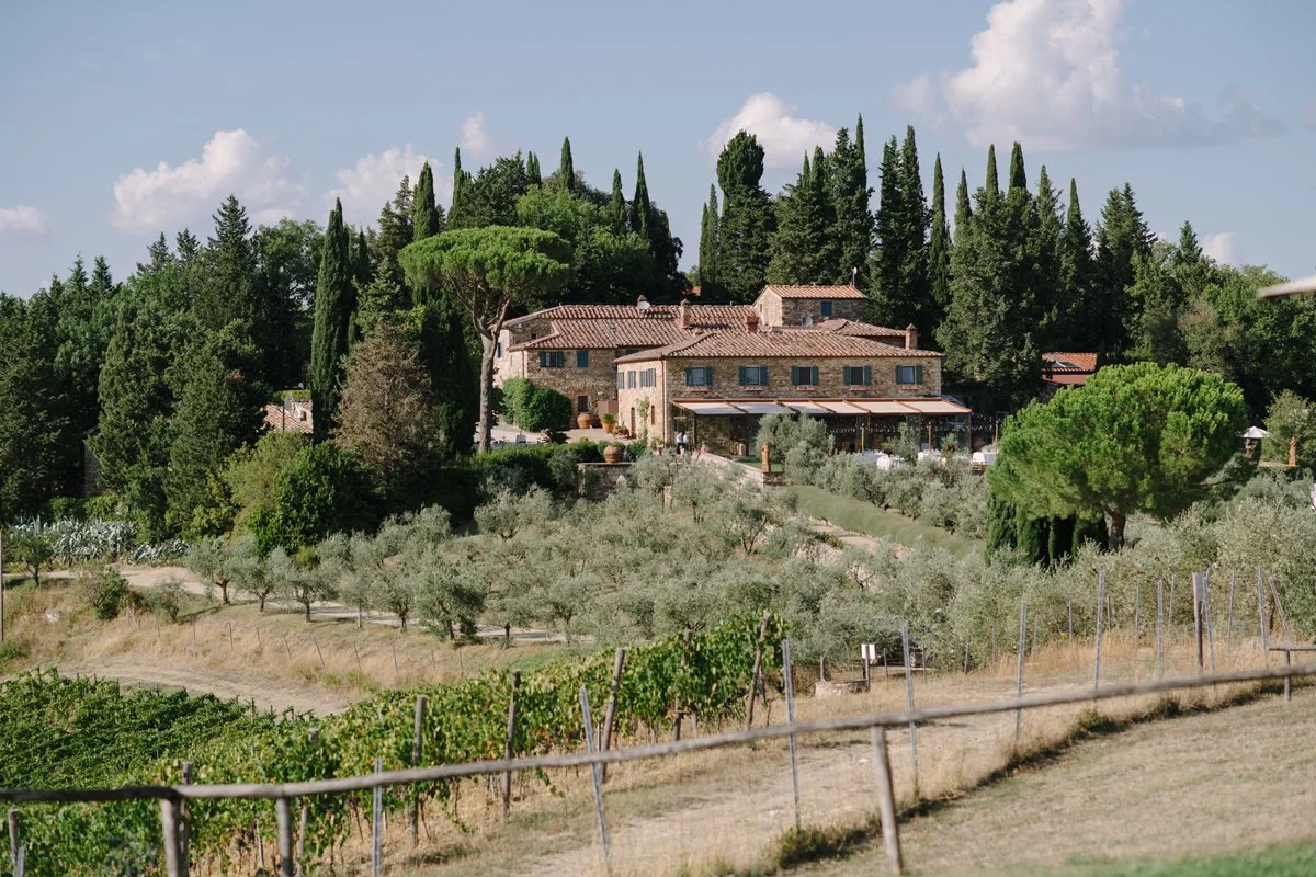 Wine estate wedding venue in Tuscany showing the main house at Le Filigare surrounded by vineyards, illustrating how countryside estates create relaxed guest flow and long outdoor celebrations.