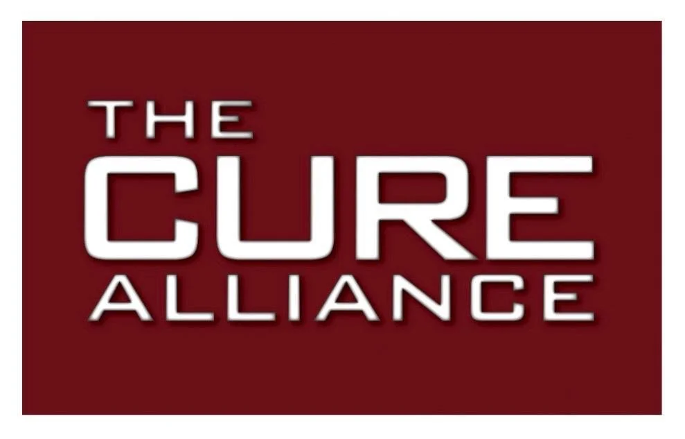 Logo for The Cure Alliance with white text on a red background.