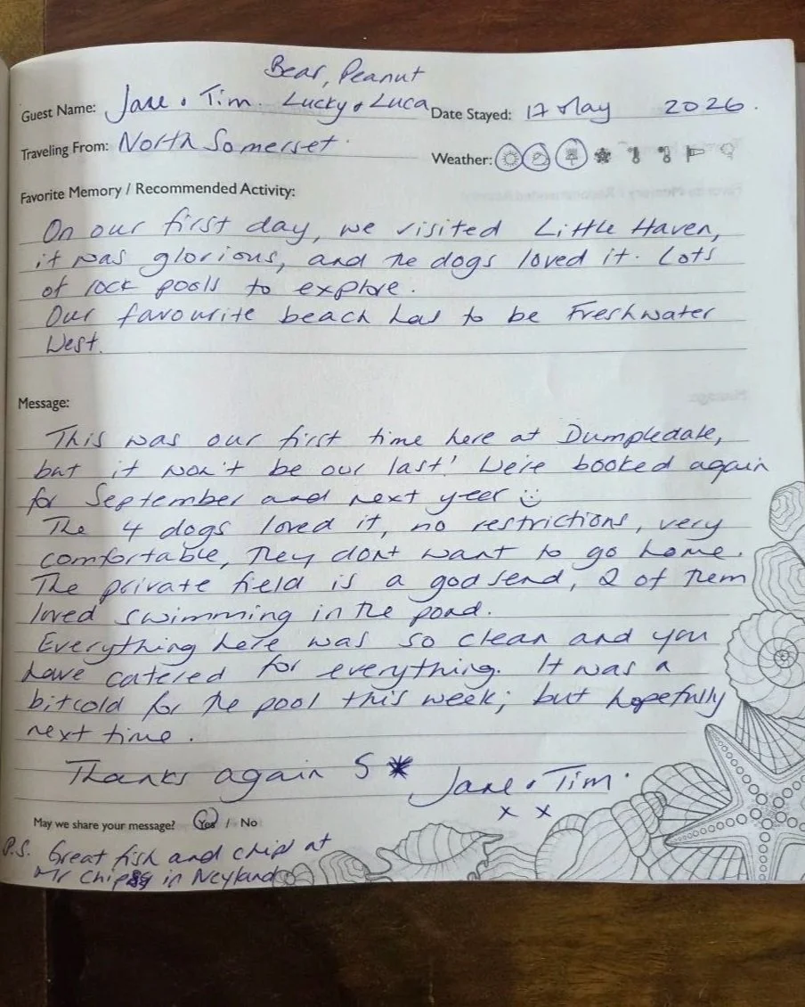 Handwritten guest message on a decorated notebook page, mentioning a visit to Little Haven, details about dogs and swimming, and a thank you note signed by Jane and Tim.