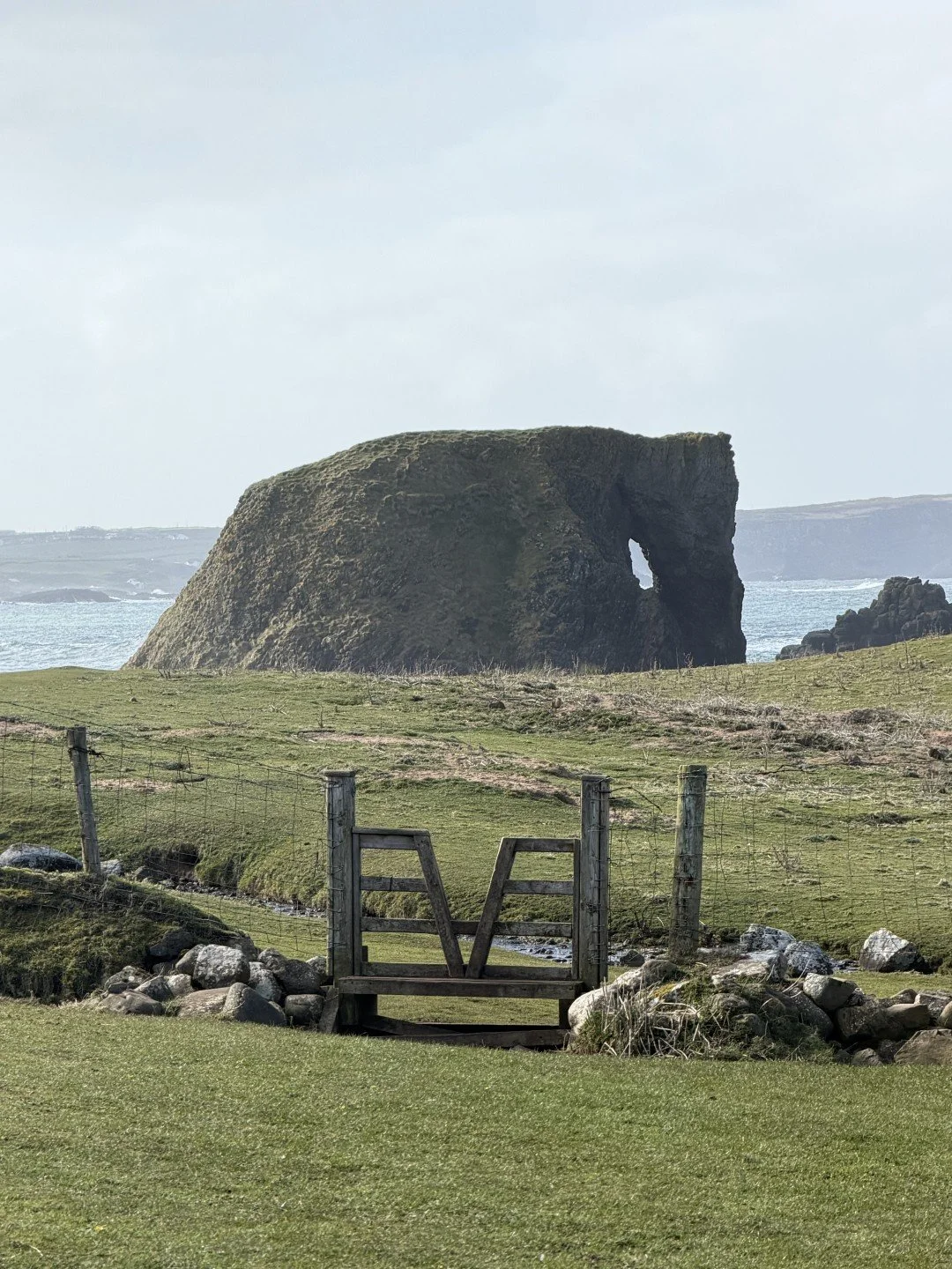 This striking rock formation is one of the most famous hidden gems along the Antrim Coast Road, located just west of Ballintoy Harbour.As you follow the coastal path toward the sweeping golden sands of White Park Bay Beach, the dark basalt cliffs nat