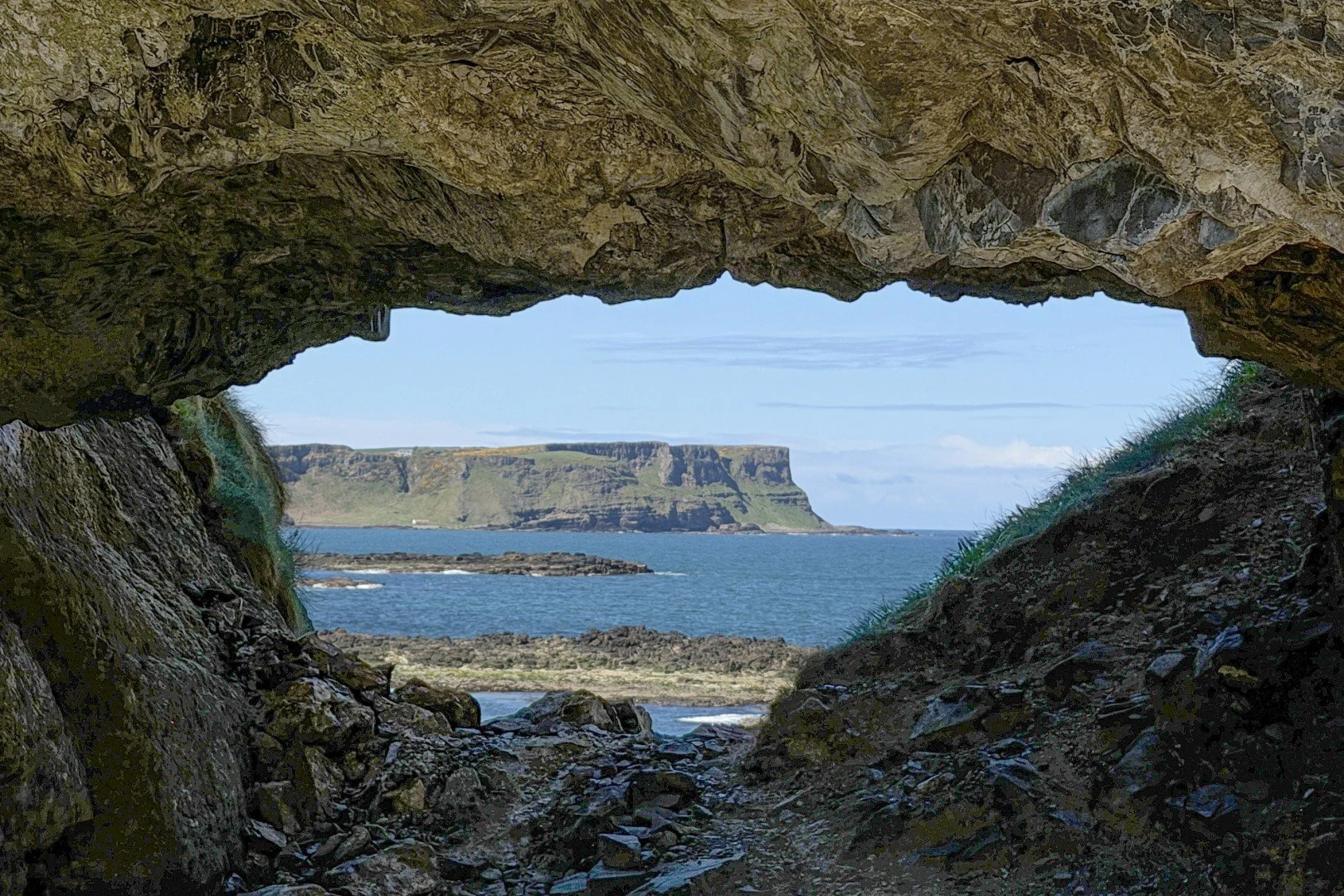 Starting from the quiet, traditional fishing hamlet of Portbradden, the trail leads you westward along a highly dramatic shoreline. Early in the walk, you pass through the stunning natural sea arch locally known as "The Eye" (or Portbradden