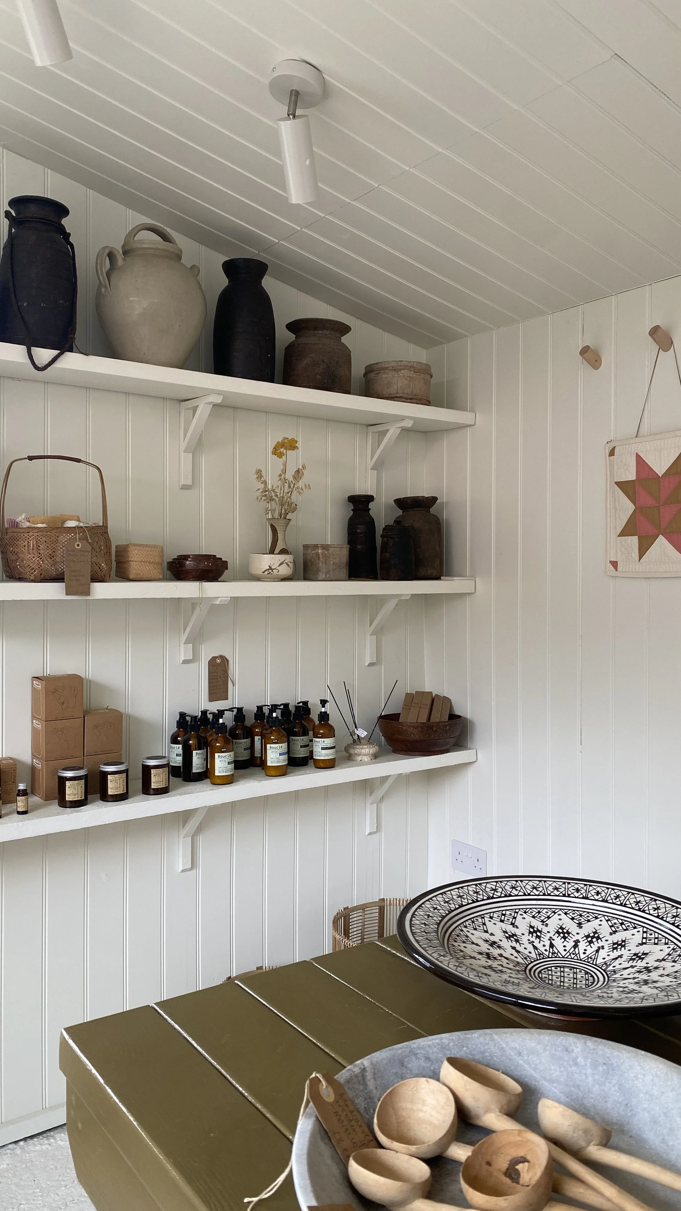 Antique vase, vintage vessels, Moroccan platters in a potting shed shop showcasing independent shopping in East Sussex.